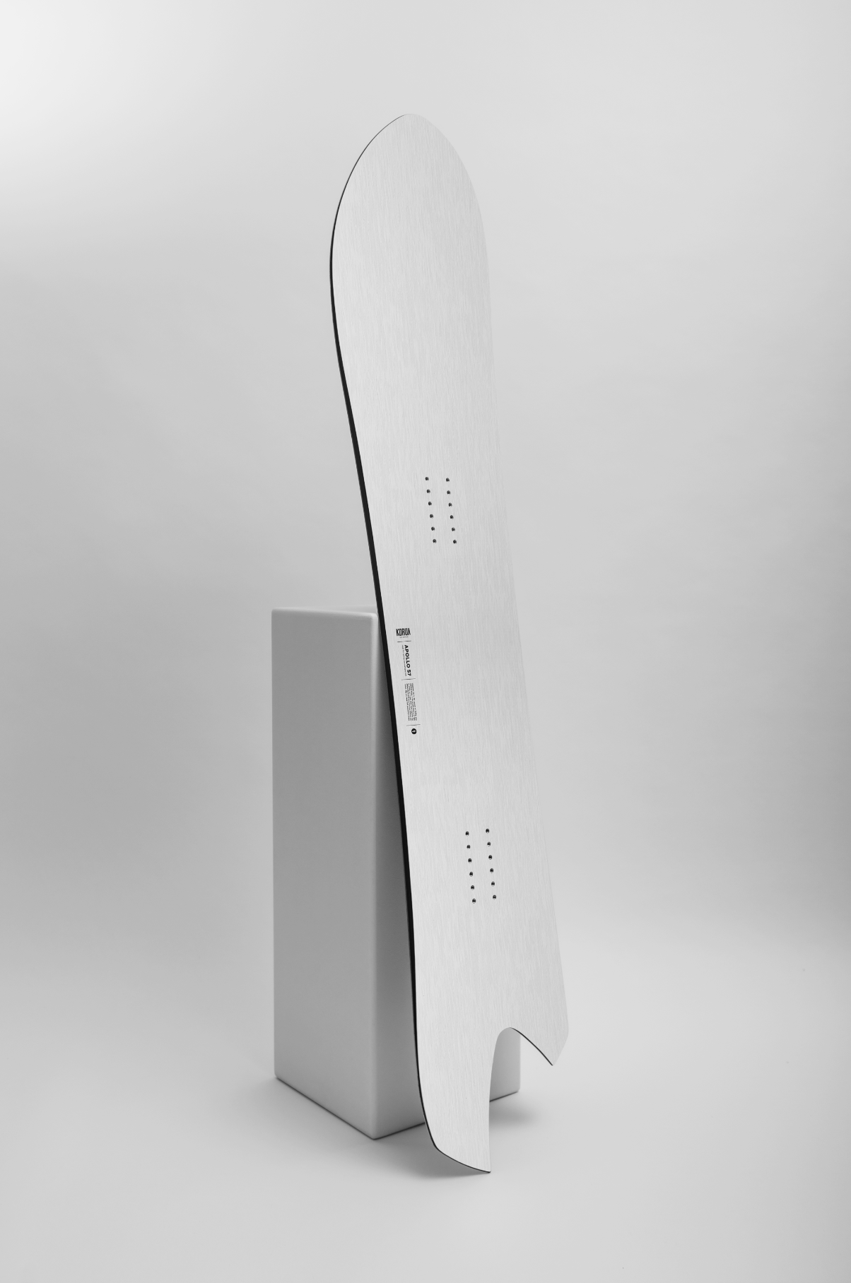 Korua Apollo Snowboard on snow, showcasing its sleek design and branding in a Milosport Studio shot.