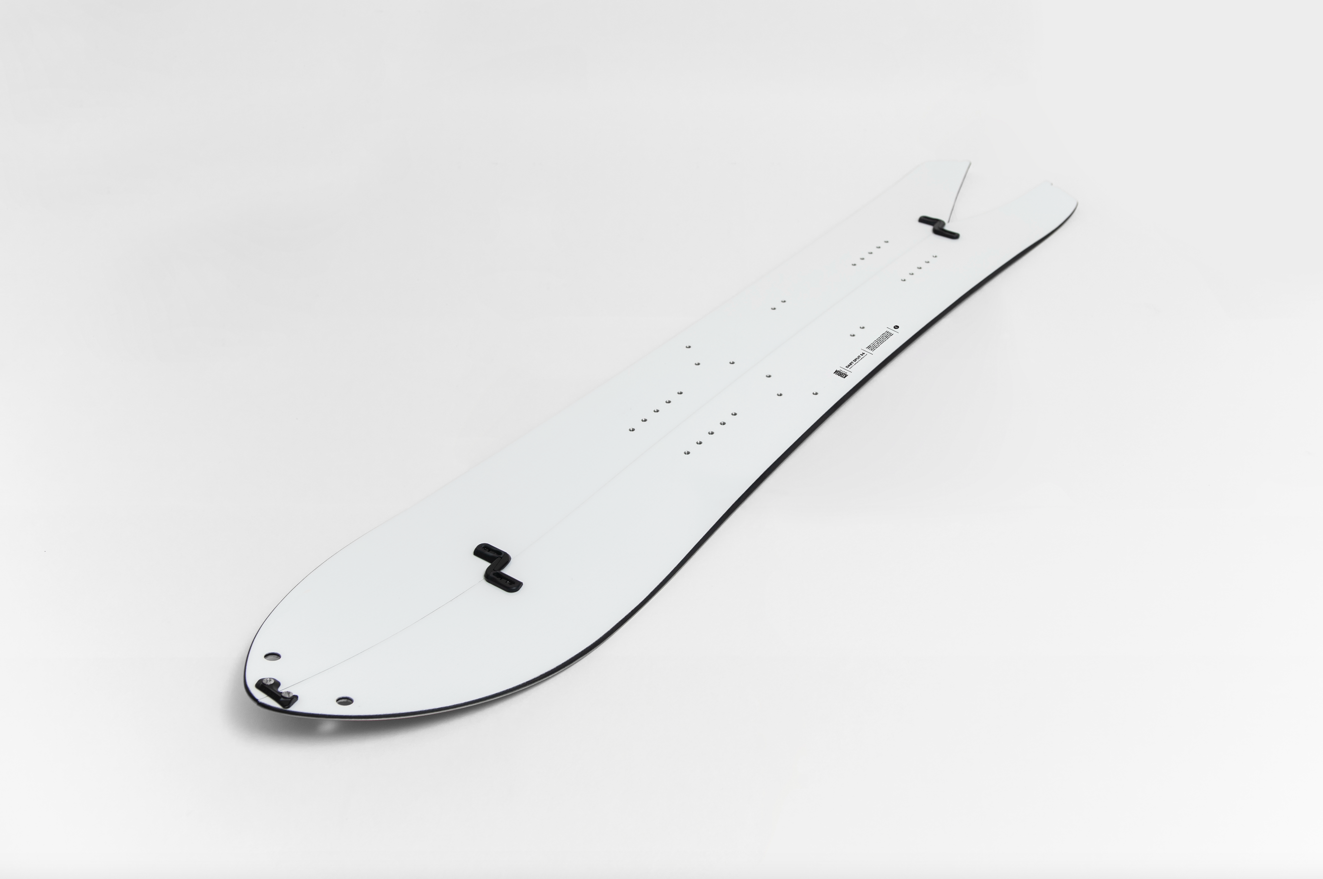 Korua Dart Split Snowboard outdoors, showing its split design and sleek shape for backcountry snowboarding adventures.