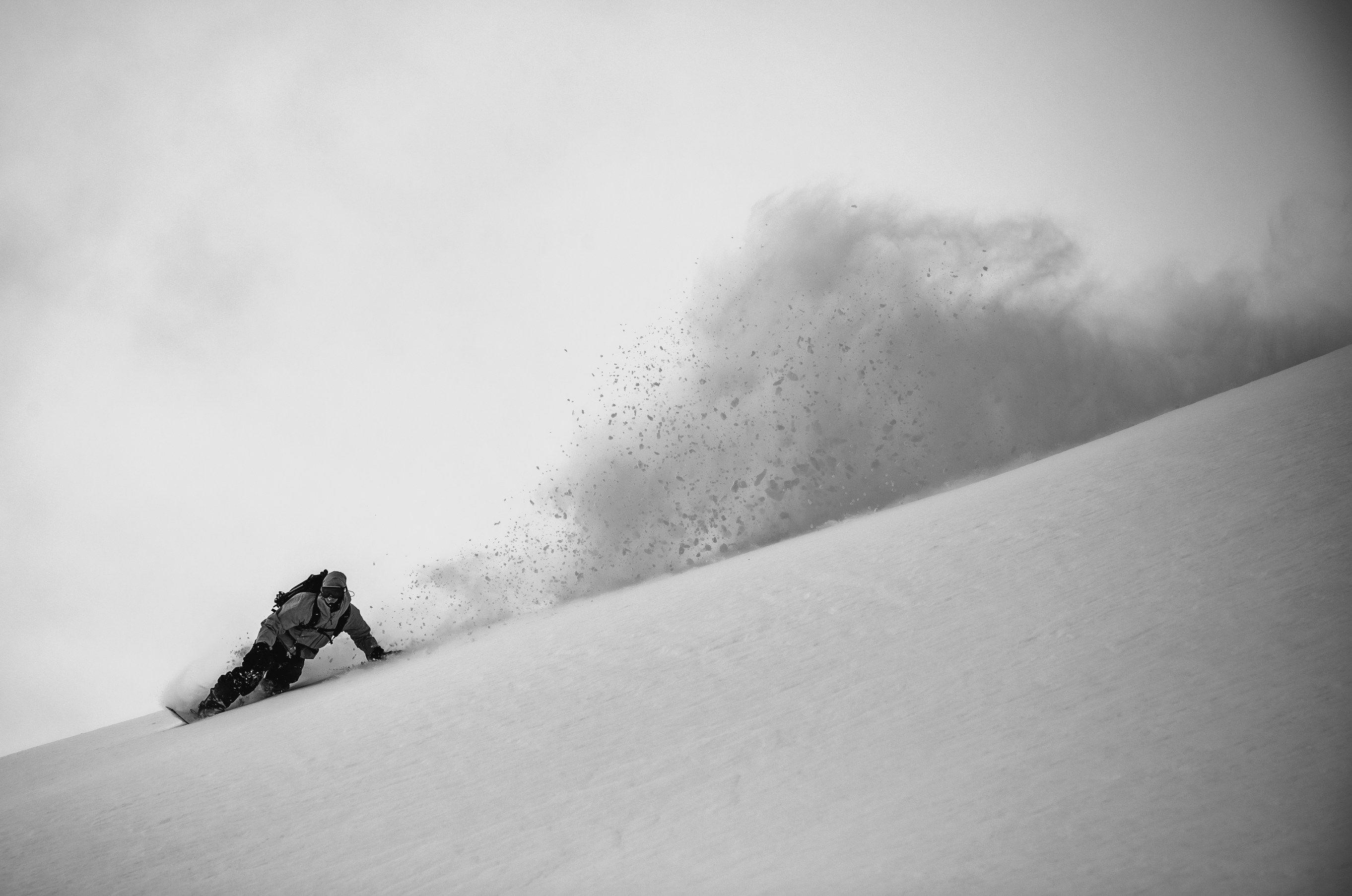 Korua Dart Split Snowboard showing toeside edge in a snowy landscape, designed for splitboarding and winter snow adventures.