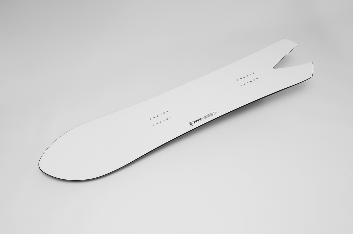 Korua Dart snowboard in studio, side view, showcasing its unique shape and design for snowboarding enthusiasts.