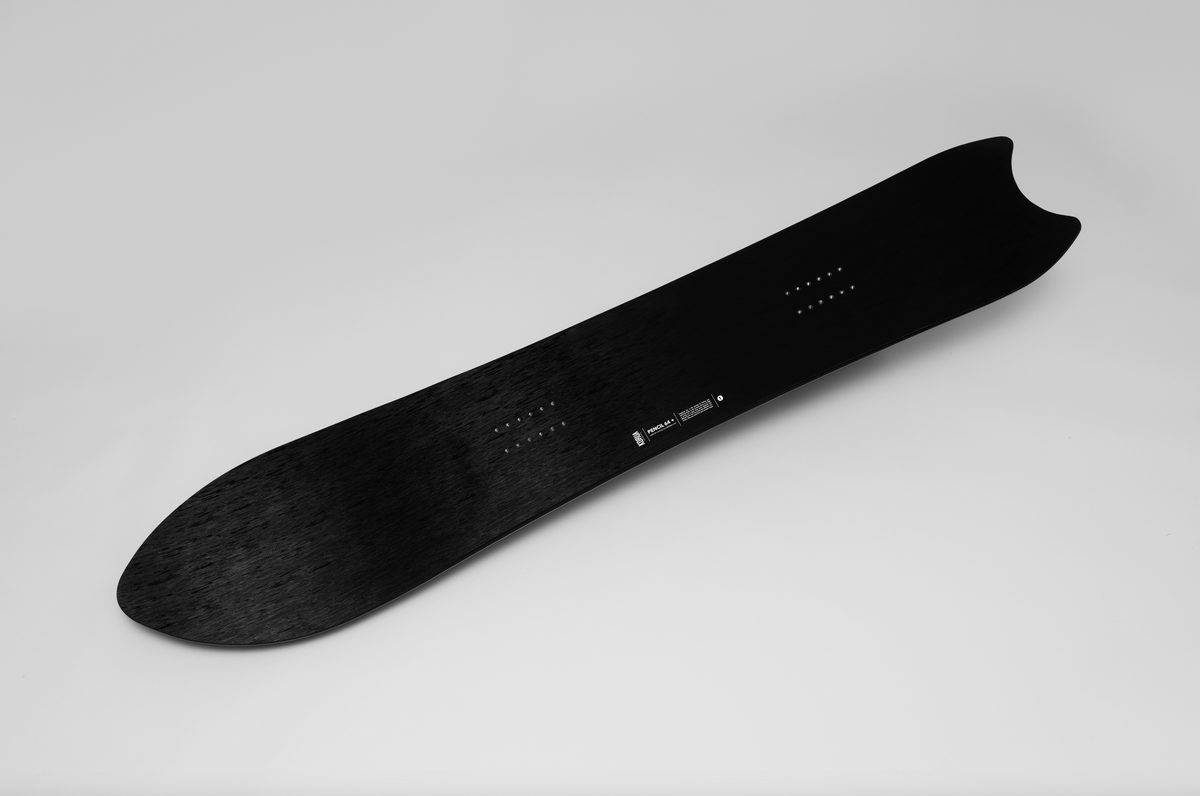 Korua Pencil Plus snowboard in a studio shot, showcasing its sleek design and shape for winter snowboarding adventures.