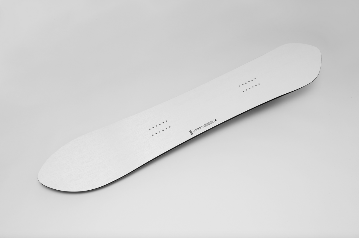 Korua Pin Tonic snowboard in snow, showcasing its unique shape and design, perfect for winter sports and snowboarding enthusiasts.