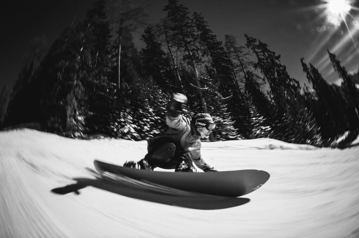 Korua Pin Tonic snowboard shown from heelside angle, featuring a sleek snowboarding design by Korua.