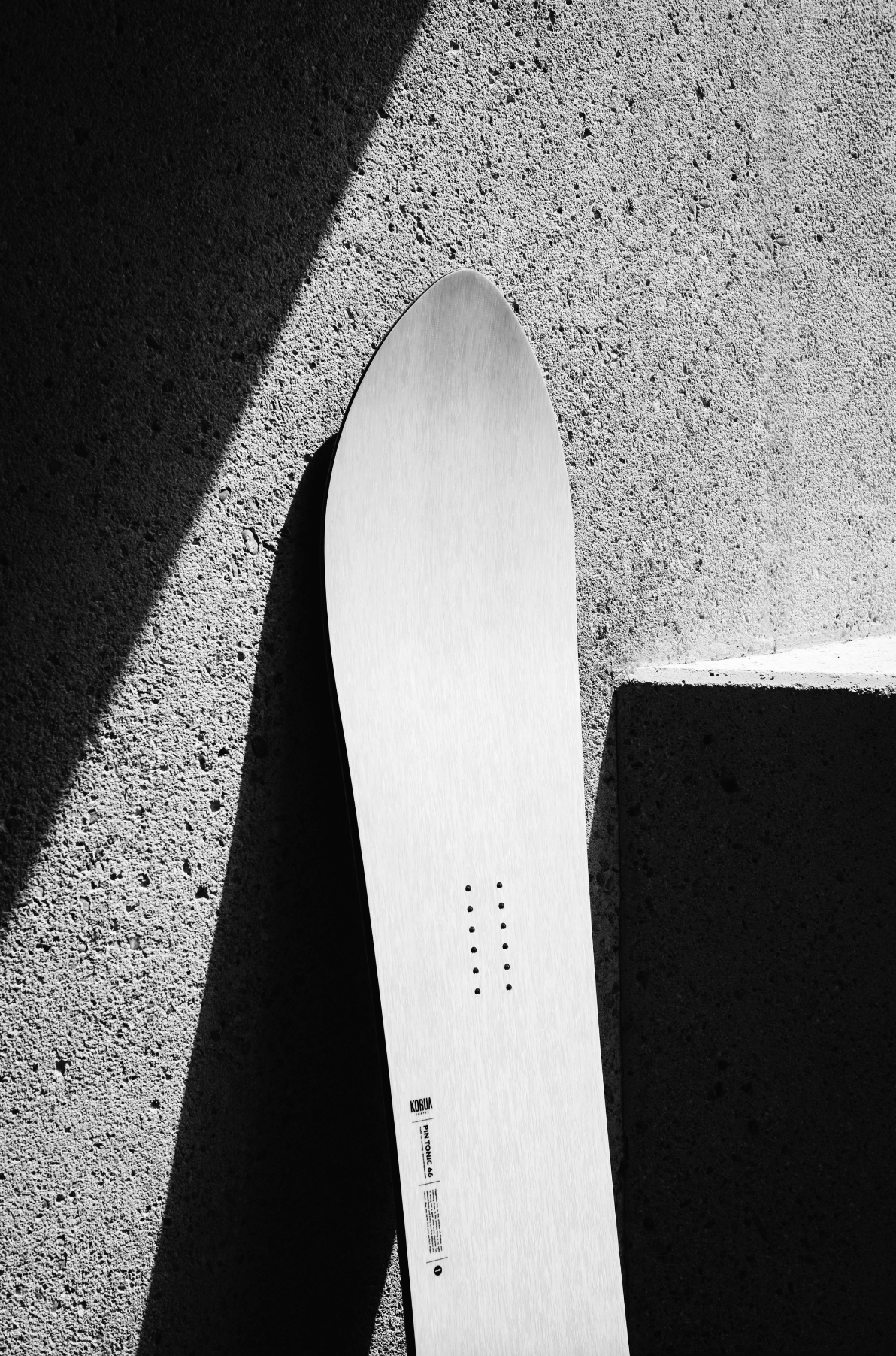 Korua Pin Tonic Snowboard outdoors, showing the nose and top design, designed for snowboarding enthusiasts.