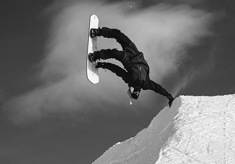 Korua Pocket Rocket snowboard with a hand-lifted mountain graphic, designed for snowboarding in snowy mountain terrain.