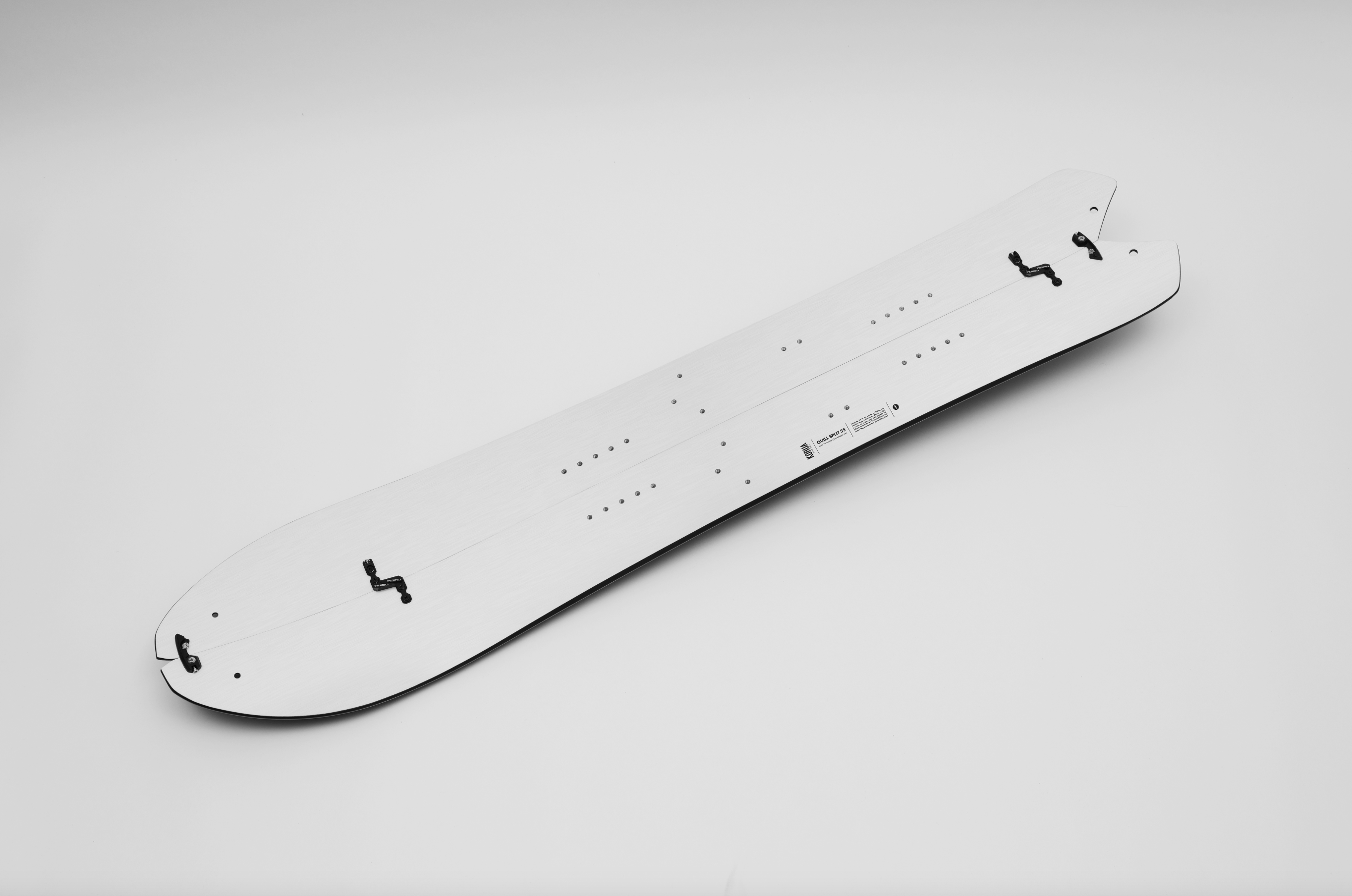 Korua Quill Split Snowboard shown on a snowy landscape, highlighting its split design and durable construction for backcountry snowboarding.