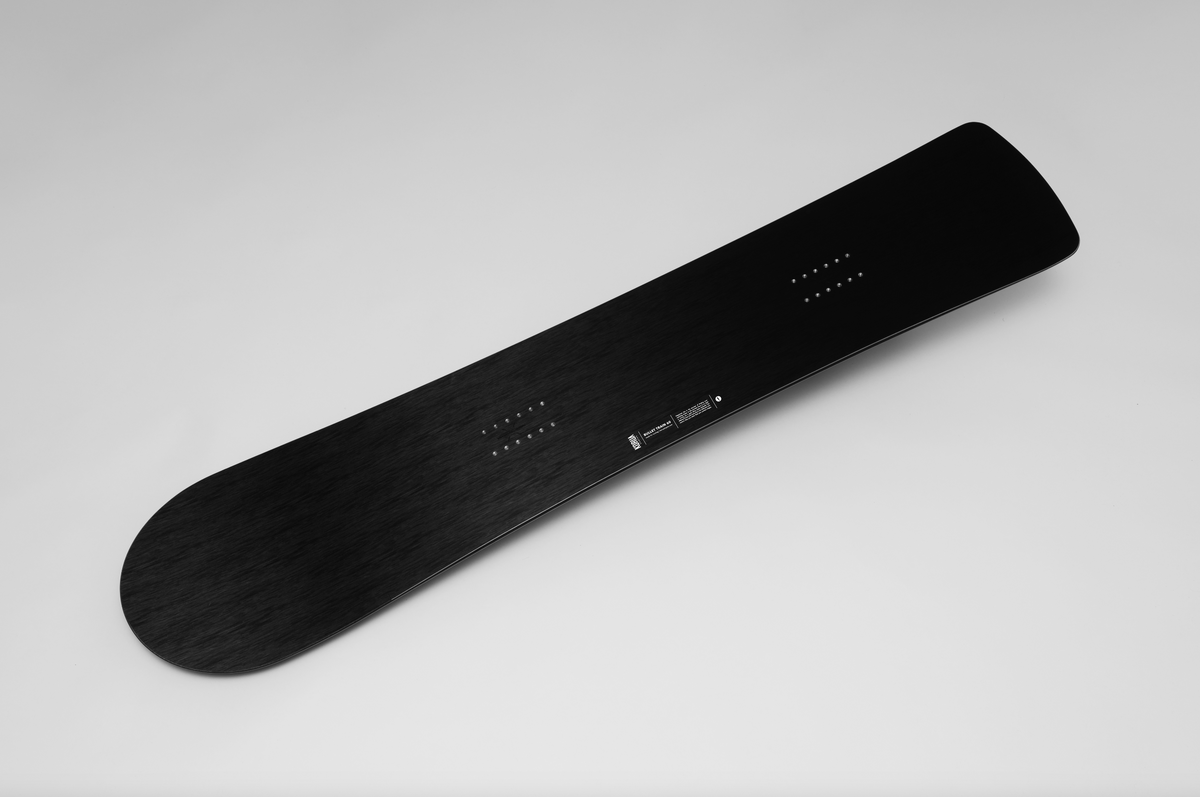 Korua Bullet Train Plus snowboard in snow, featuring a unique shape and design by Korua, ready for winter snowboarding adventures.
