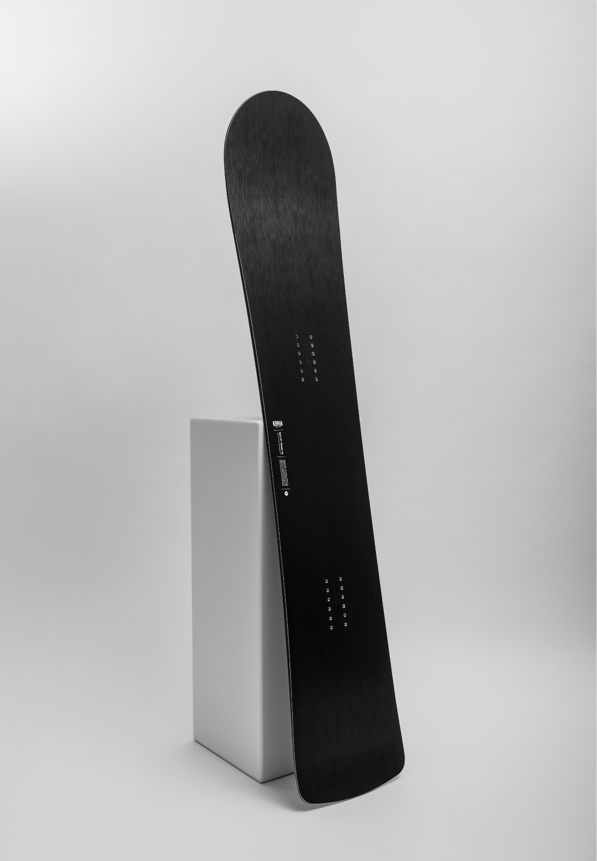 Korua Bullet Train Plus snowboard in a studio overview, showcasing its shape and design for snowboarding enthusiasts.