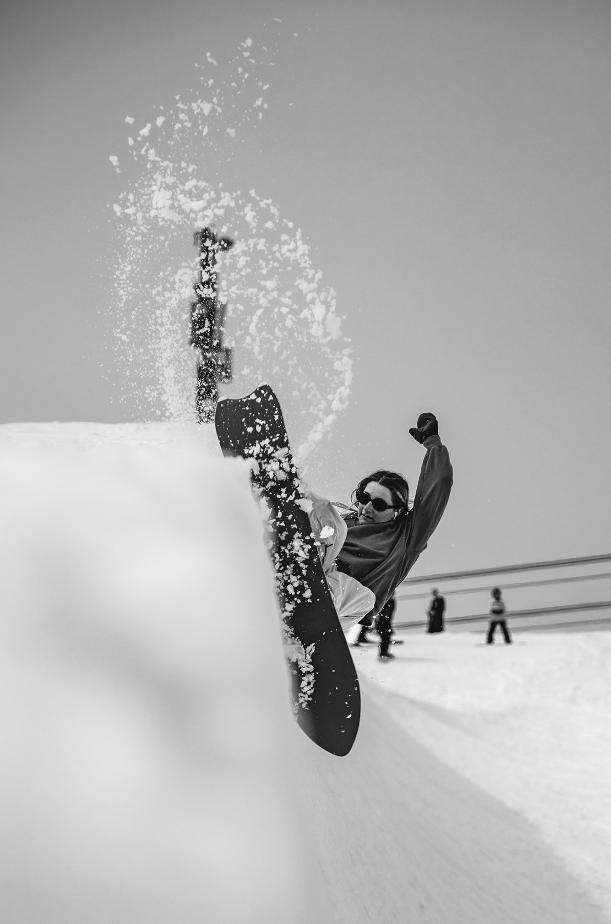 Korua Pencil snowboard in action on snow, showcasing its unique shape and design by Korua for freestyle snowboarding.