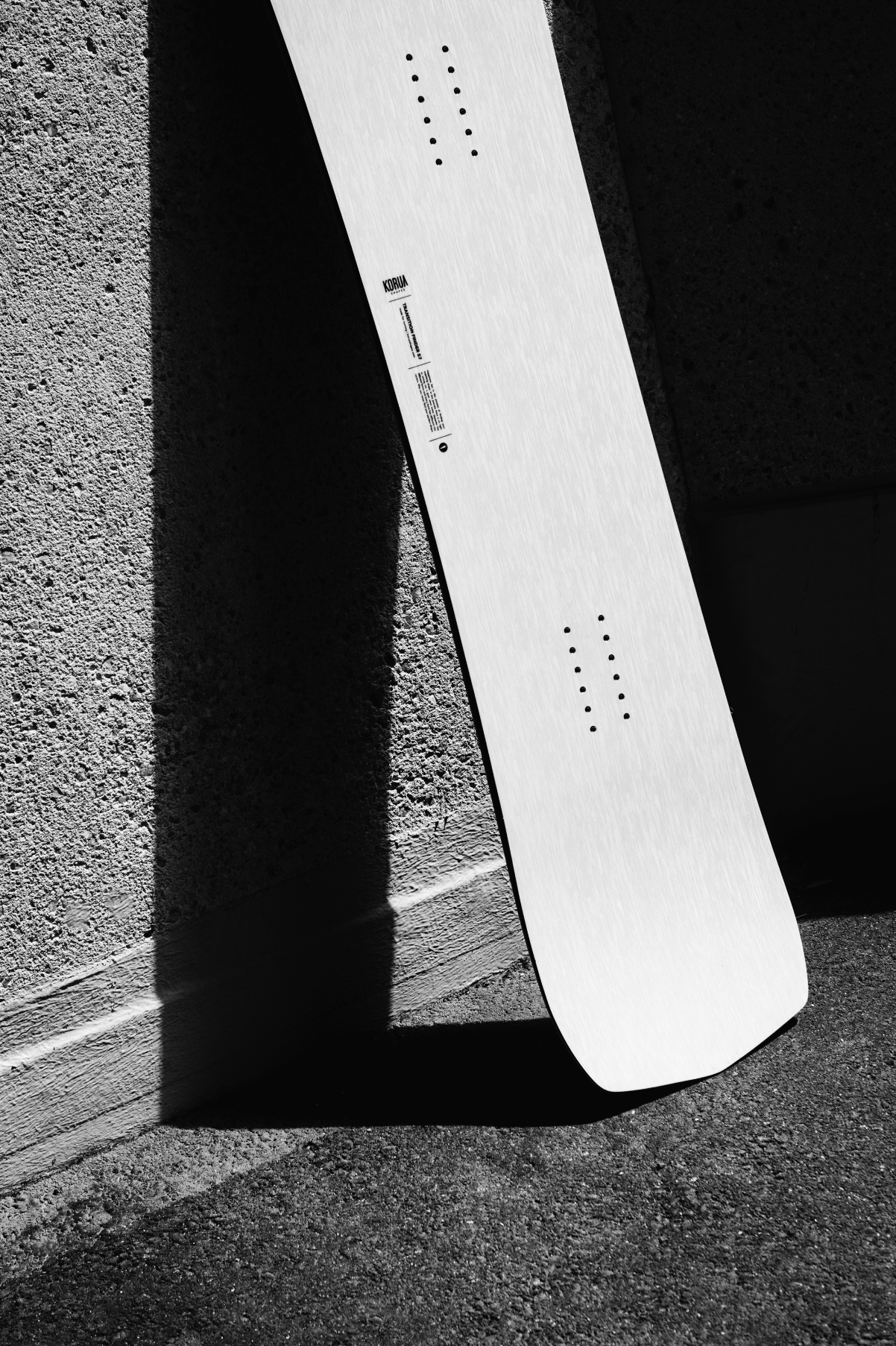 Korua Transition Finder snowboard outdoors, showing the tail and side profile