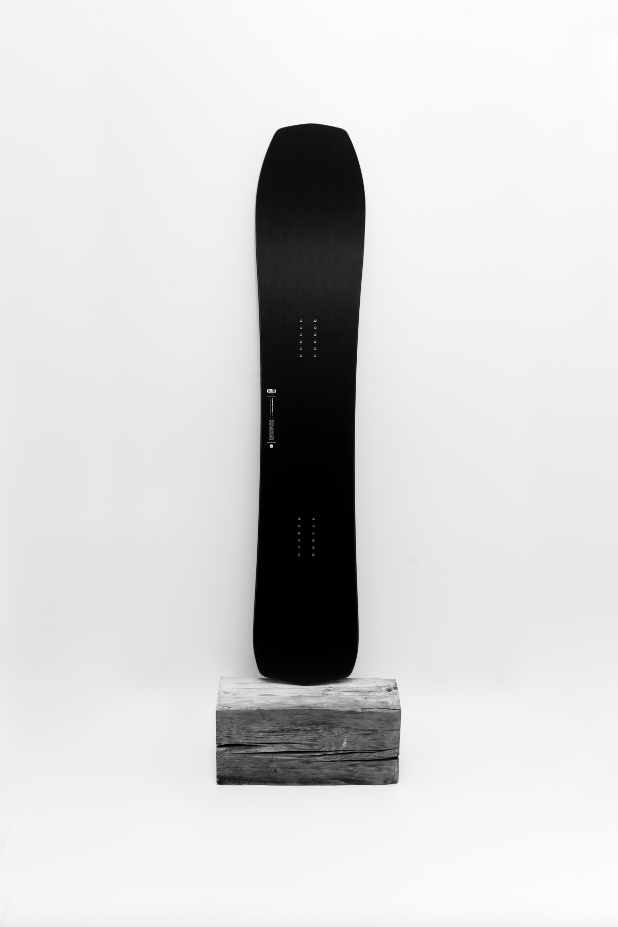 Korua Transition Finder Plus snowboard on display, showcasing its design and graphics in a studio setting.
