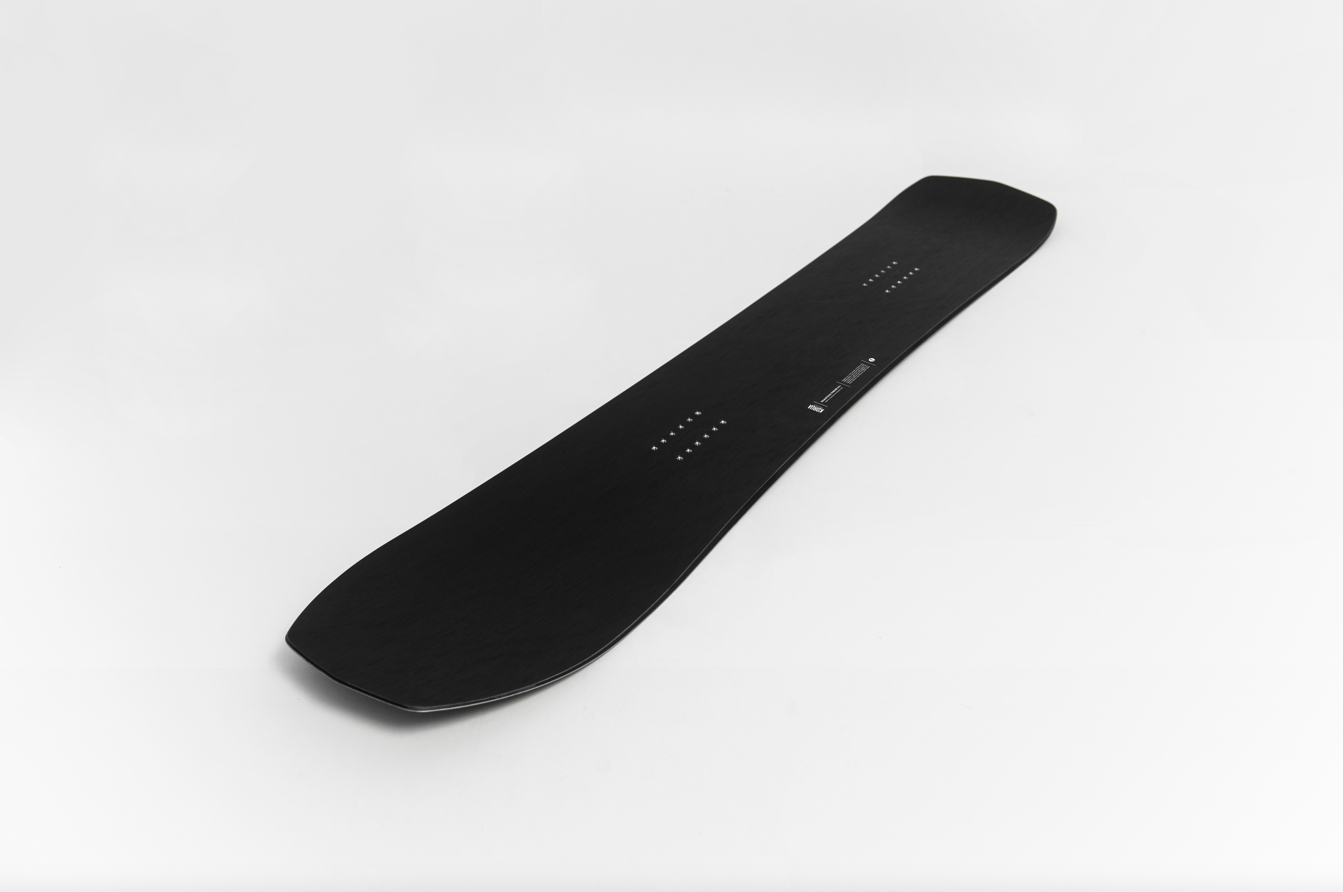Korua Transition Finder Plus snowboard displayed on studio background, showcasing its design and shape for winter snowboarding.