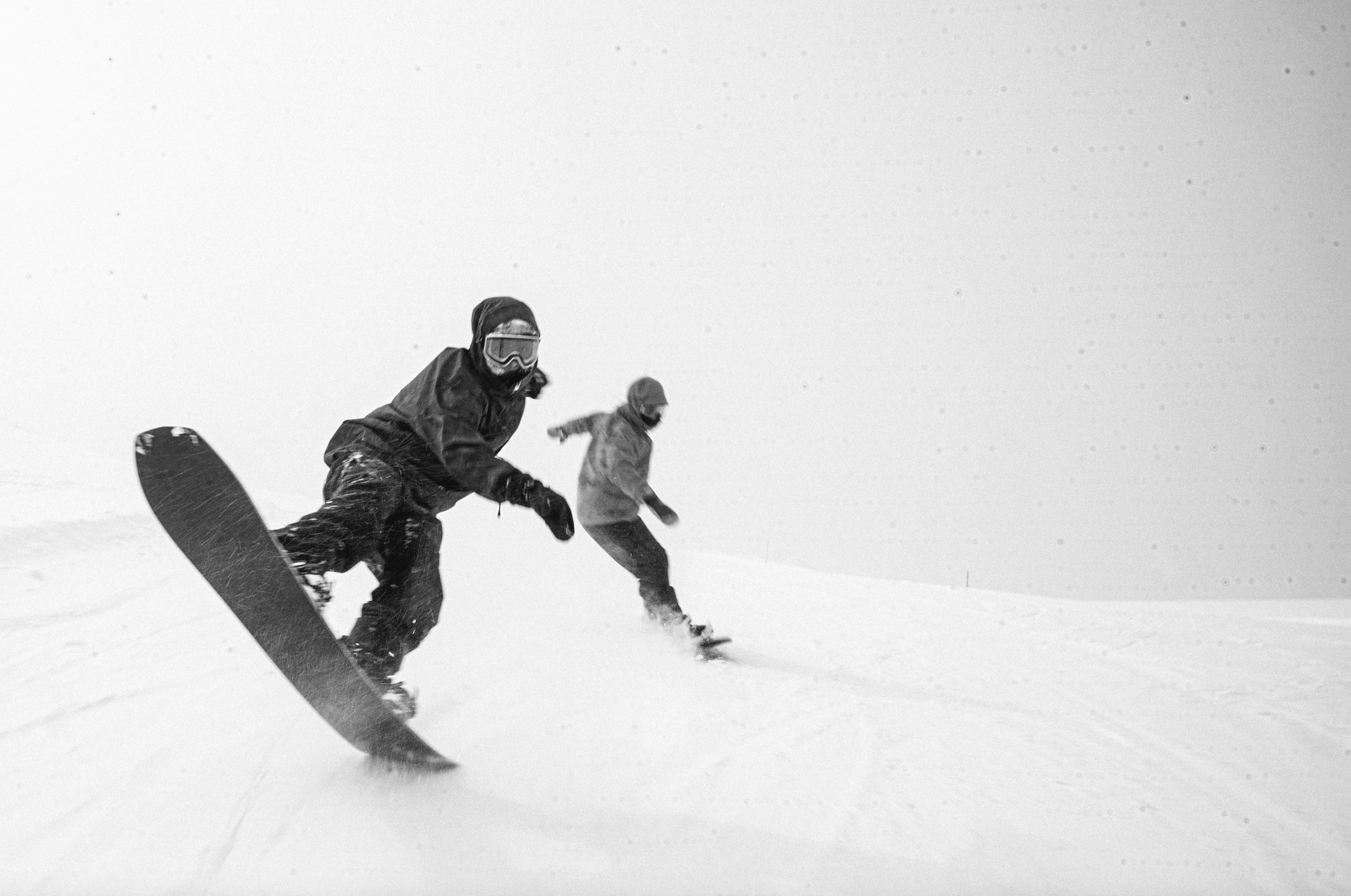 Korua Transition Finder Plus snowboard with tail scooter design, showcasing a snowy landscape and the snowboard's unique shape.