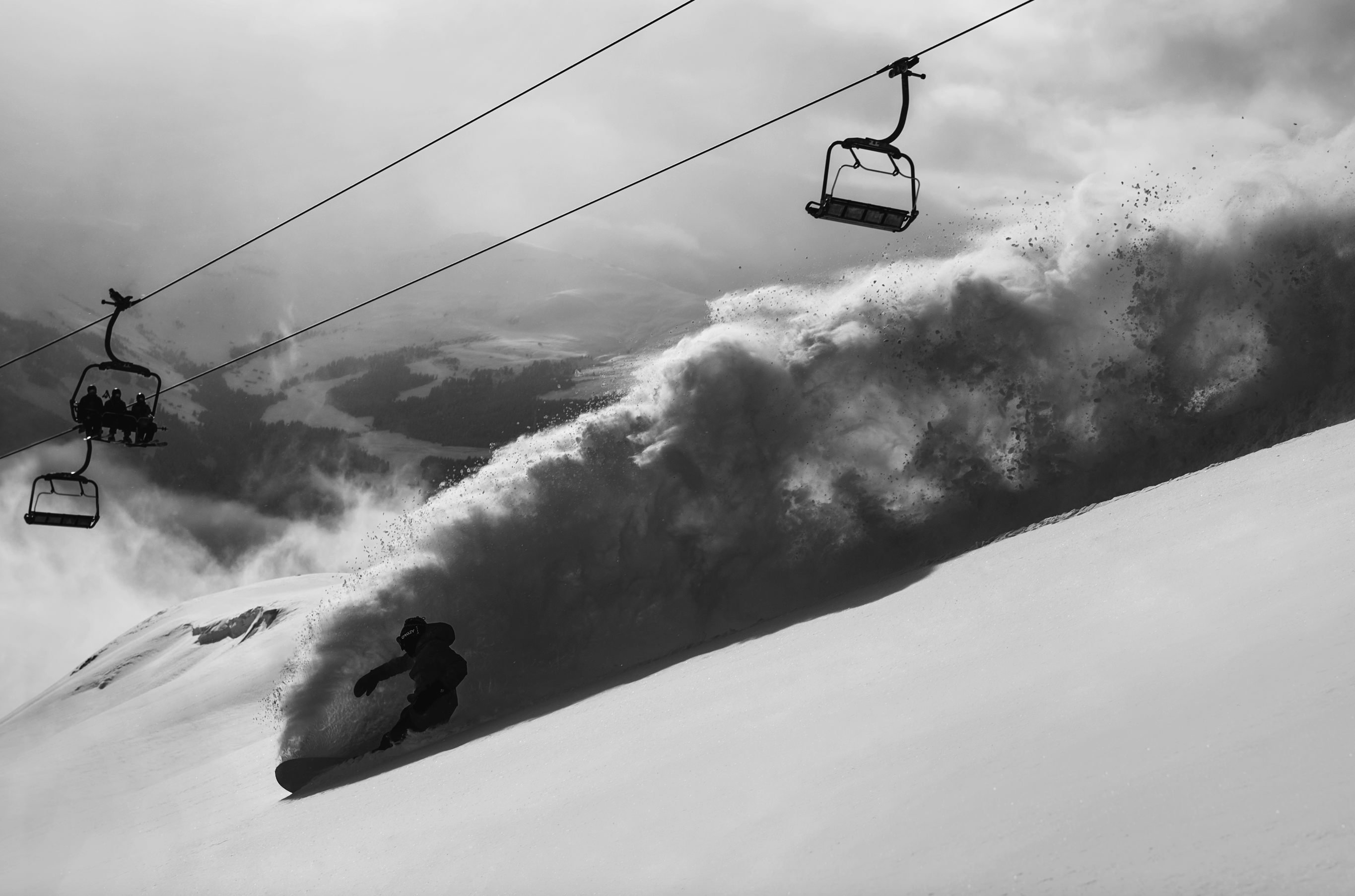 Korua Uberegg snowboarding snowboard with a chairlift view and Milosport branding, showcasing its design on snow.