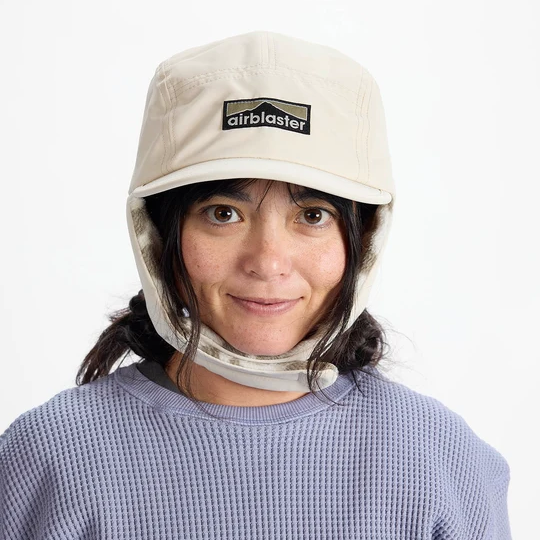 Airblaster Air Flap Cap 2027 in Bone shown from the front with Airblaster logo patch and fleece-lined ear flaps down.