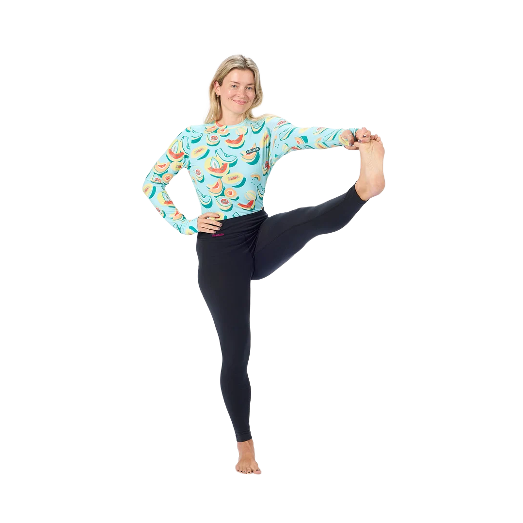 Airblaster Women’s Base Layer Bottom 2027 in Black shown in a stretch pose highlighting the flexible fit and four-way stretch construction.