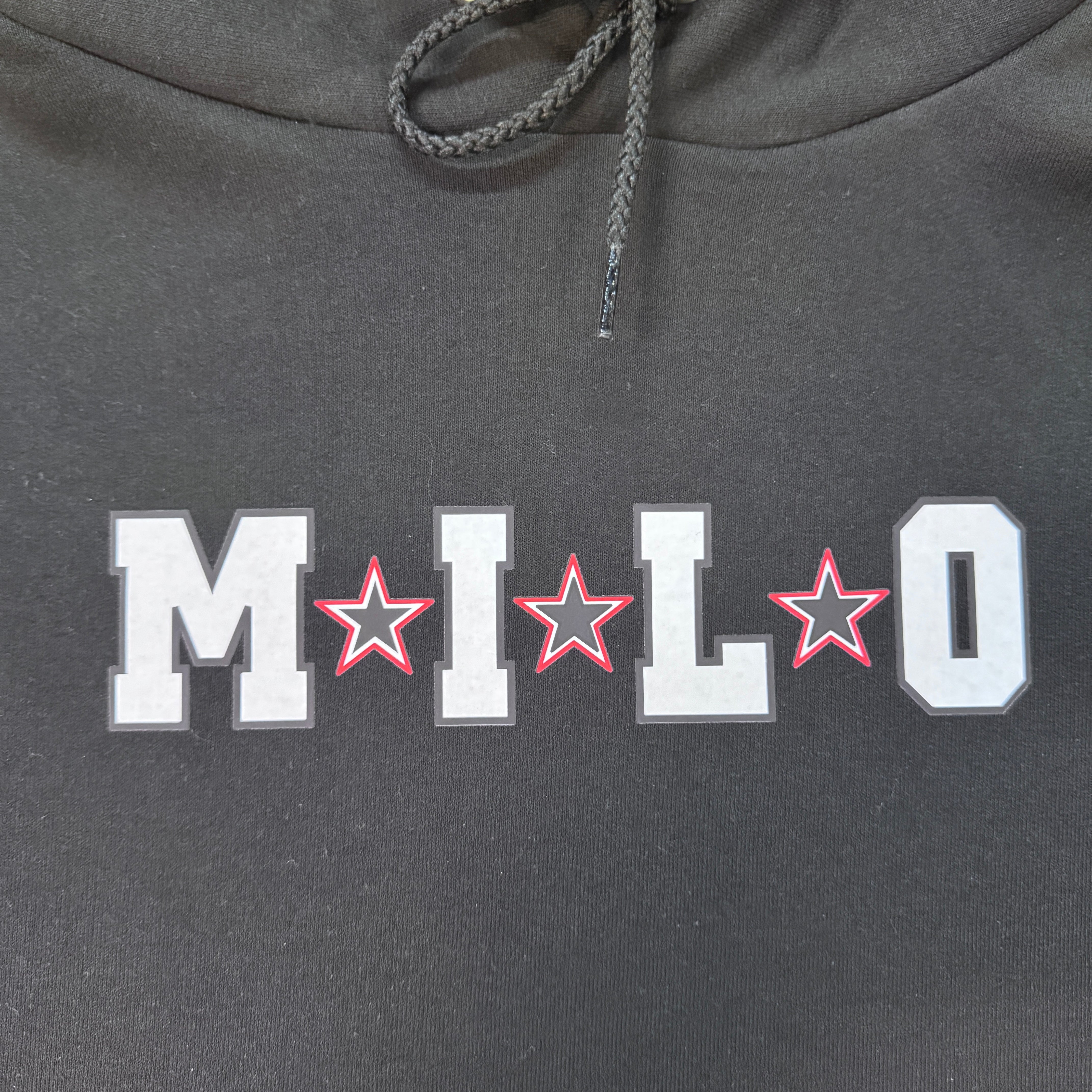 Close-up of the white Milo Blend Stars chest graphic with red outlined stars on the black Milosport Champion hoodie.
