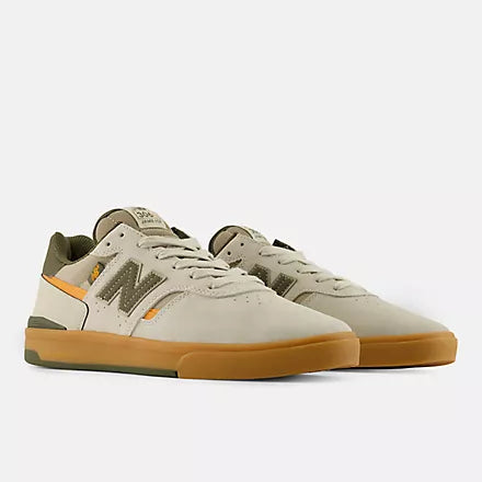 Pair of New Balance Numeric 306 Cup Foy skate shoes in grey and green shown from a front three-quarter angle with gum cupsoles.