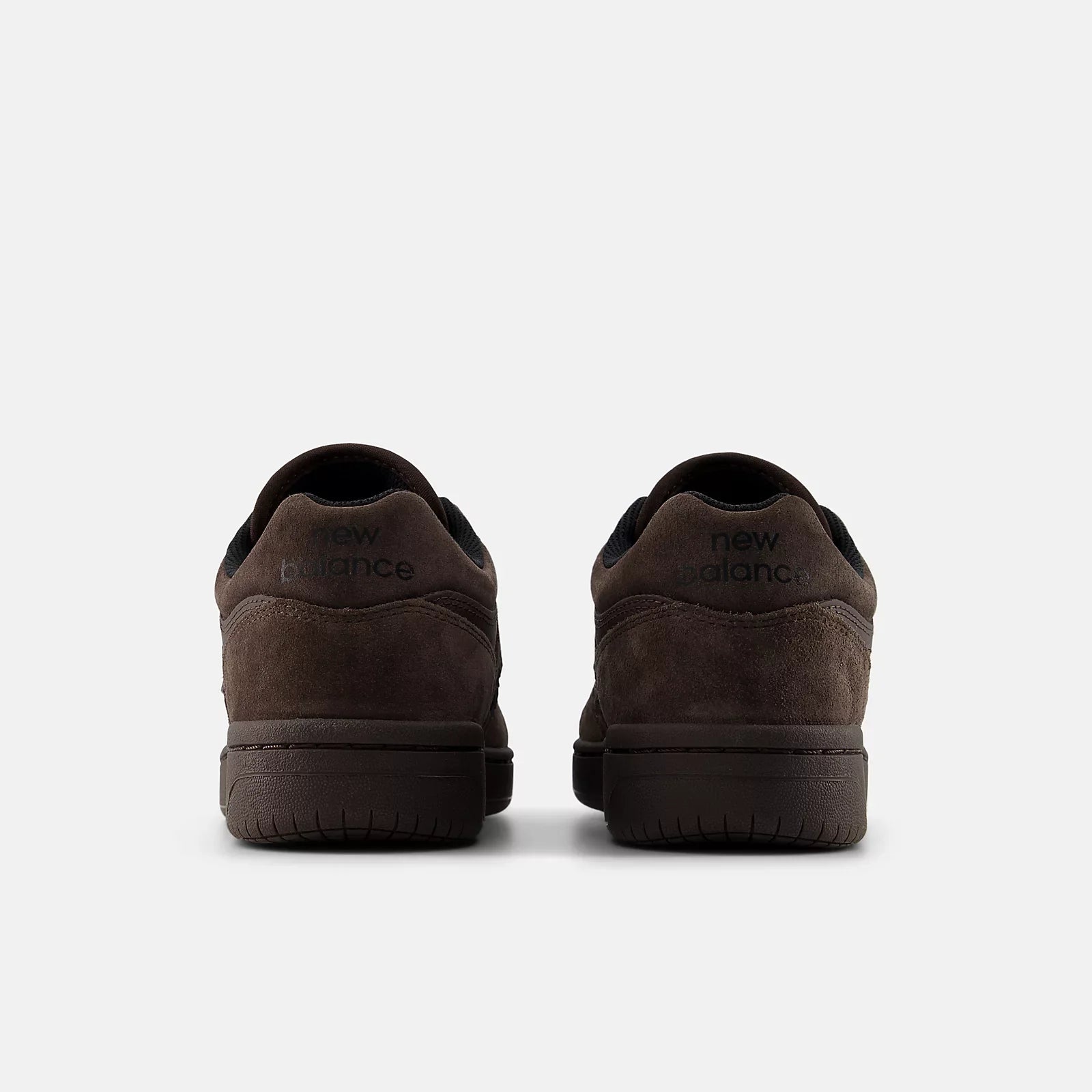 Rear view of a pair of New Balance Numeric 480 skate shoes in Chocolate Brown showing suede heel panels and New Balance heel branding.