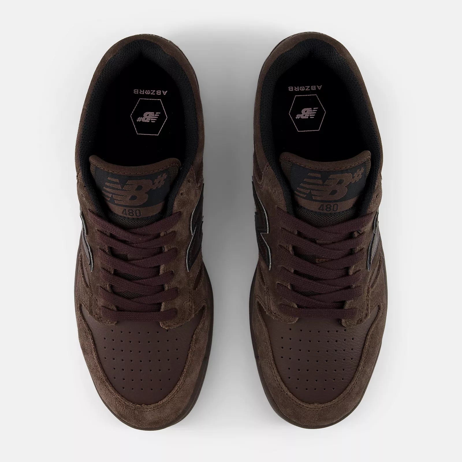 Top view of a pair of New Balance Numeric 480 skate shoes showing brown laces, perforated toe boxes, 480 tongue labels and ABZORB insoles.