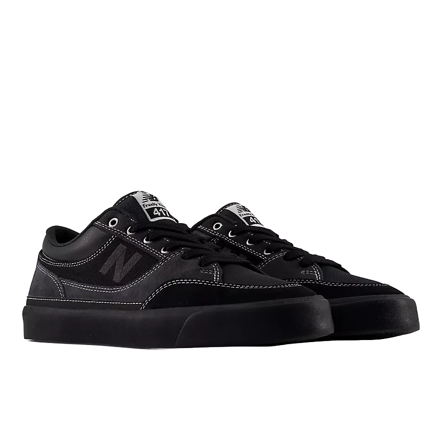 Pair of New Balance Numeric Franky Villani 417 Low skate shoes in grey and black shown from a front three-quarter angle with tonal N logos and black soles.