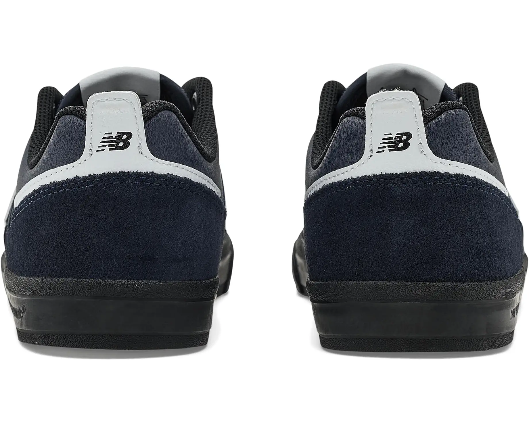 Rear view of a pair of New Balance Numeric Jamie Foy 306 skate shoes showing navy suede heels, white New Balance branding and black vulcanized soles.