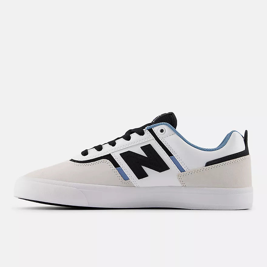 Inner side profile of the New Balance Numeric Jamie Foy 306 skate shoe in grey and white with black N logo, blue accents and white vulcanized sole.
