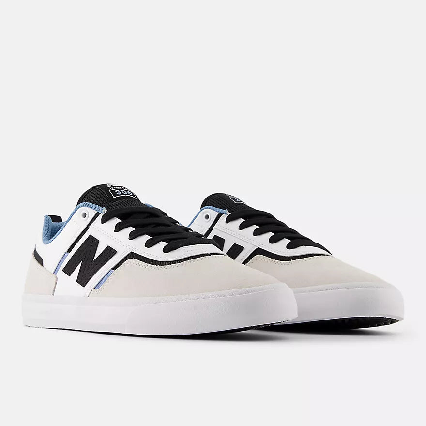 Pair of New Balance Numeric Jamie Foy 306 skate shoes in grey and white shown from a front three-quarter angle with black laces and white vulcanized soles.
