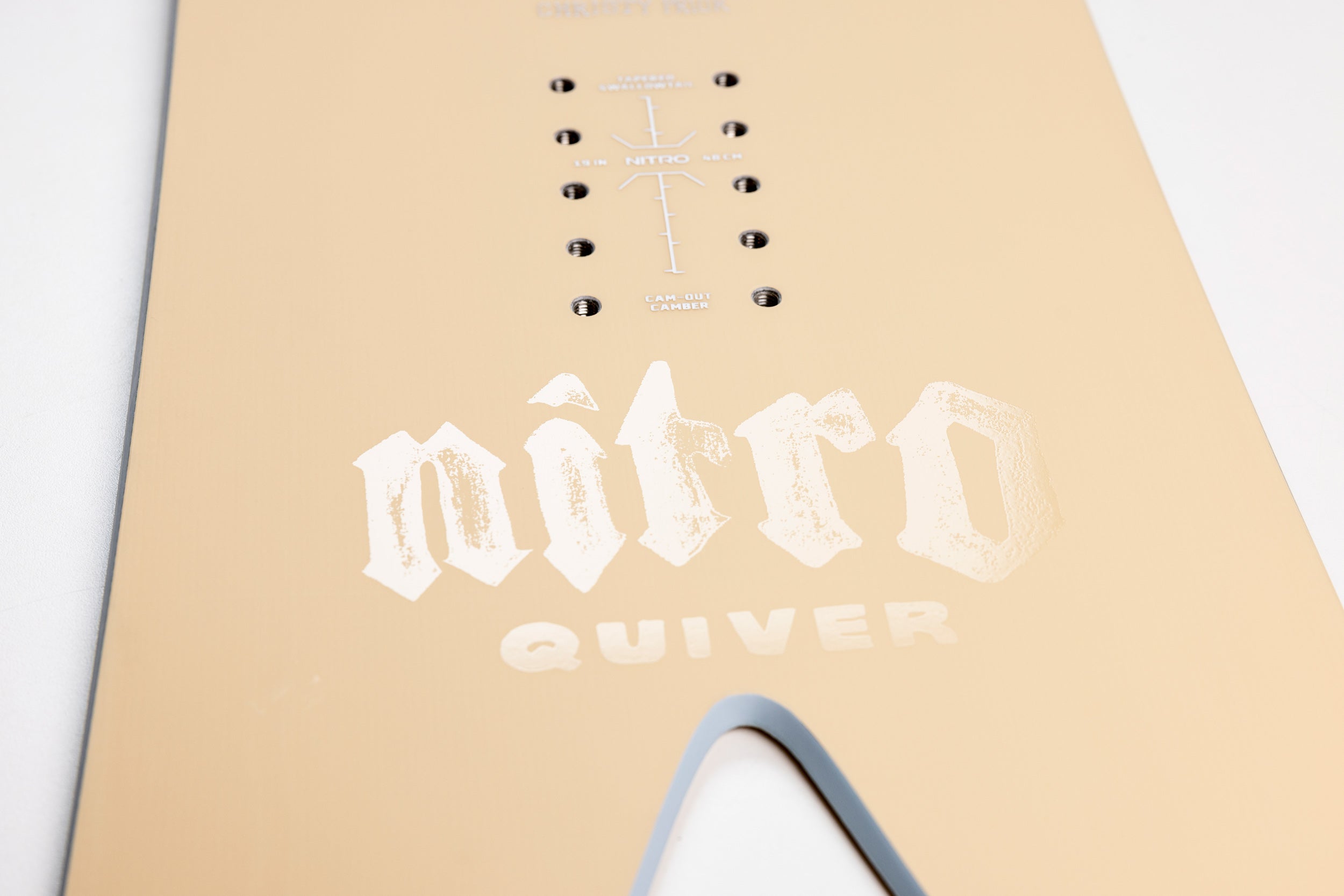 Nitro Ika Quiver Series women's snowboard 2027, showing the tail branding and detailed side view with snow surface.