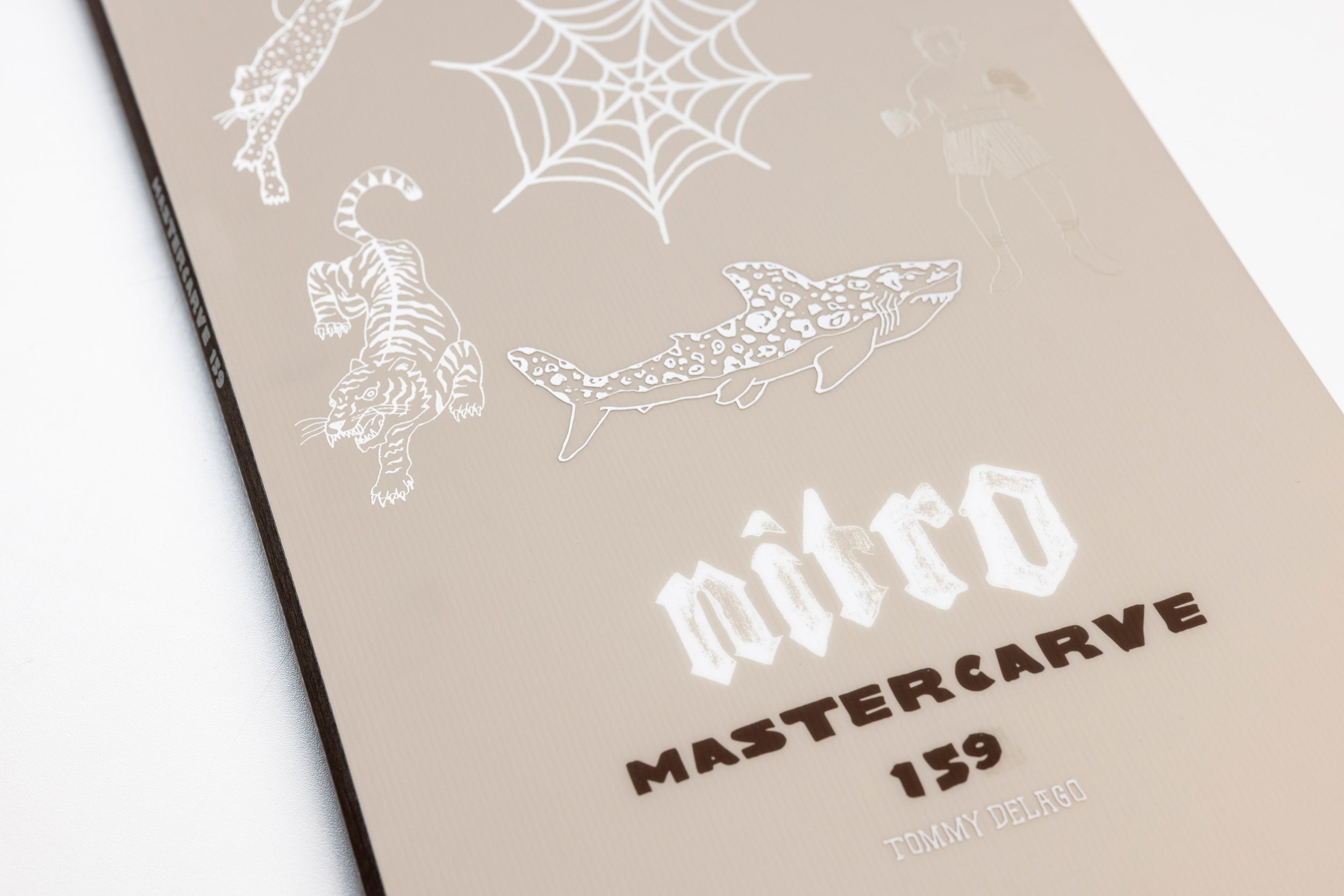 Close-up of Nitro Mastercarve Quiver Series Snowboard 2027 showing branding and detailed surface design on the snow.