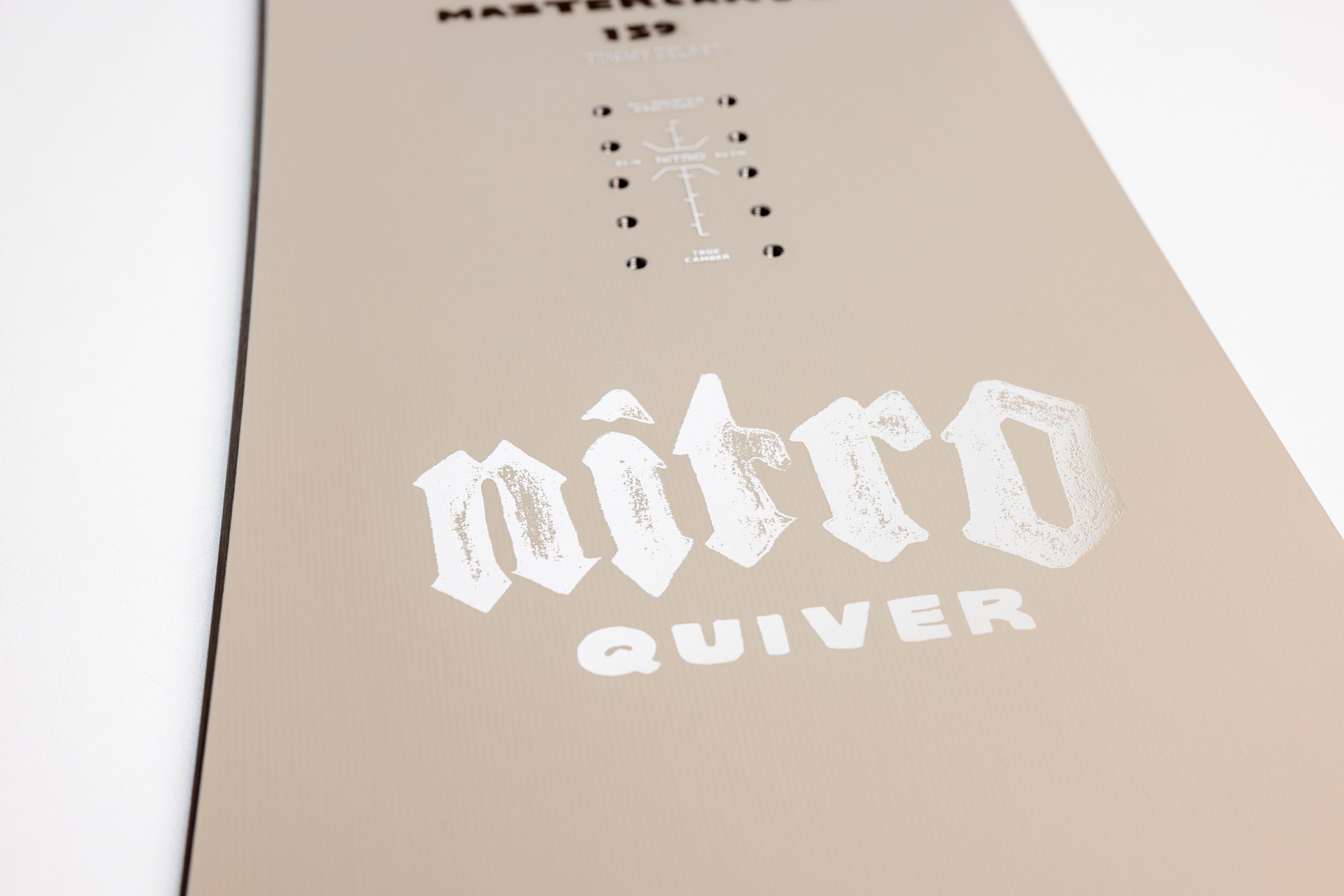 Close-up of Nitro Mastercarve Quiver Series Snowboard 2027 with Quiver logo detail on the top surface.