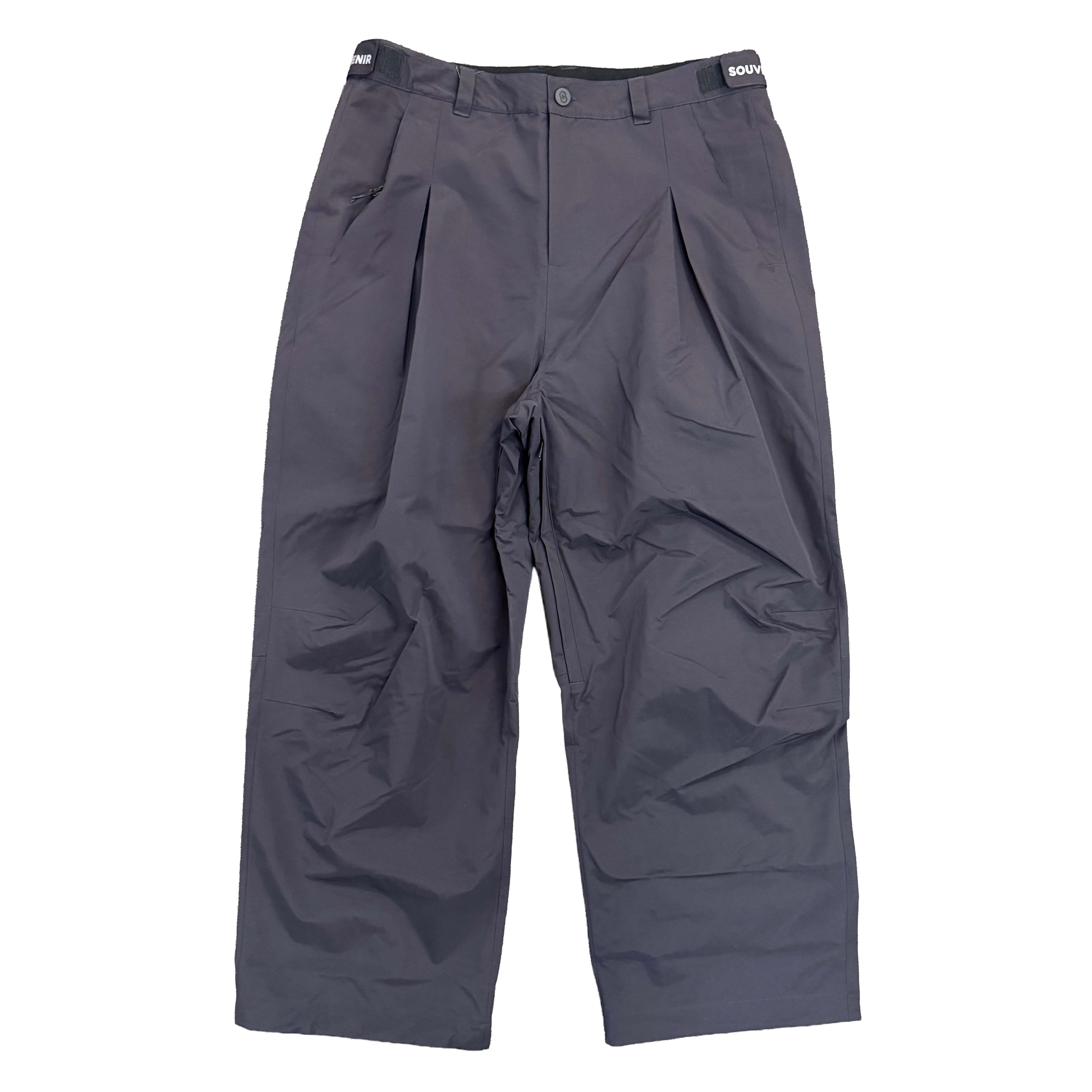Souvenir Pleated Chino Pant 2027 in Black shown from the front with oversized pleated fit, articulated knees and adjustable waistband.