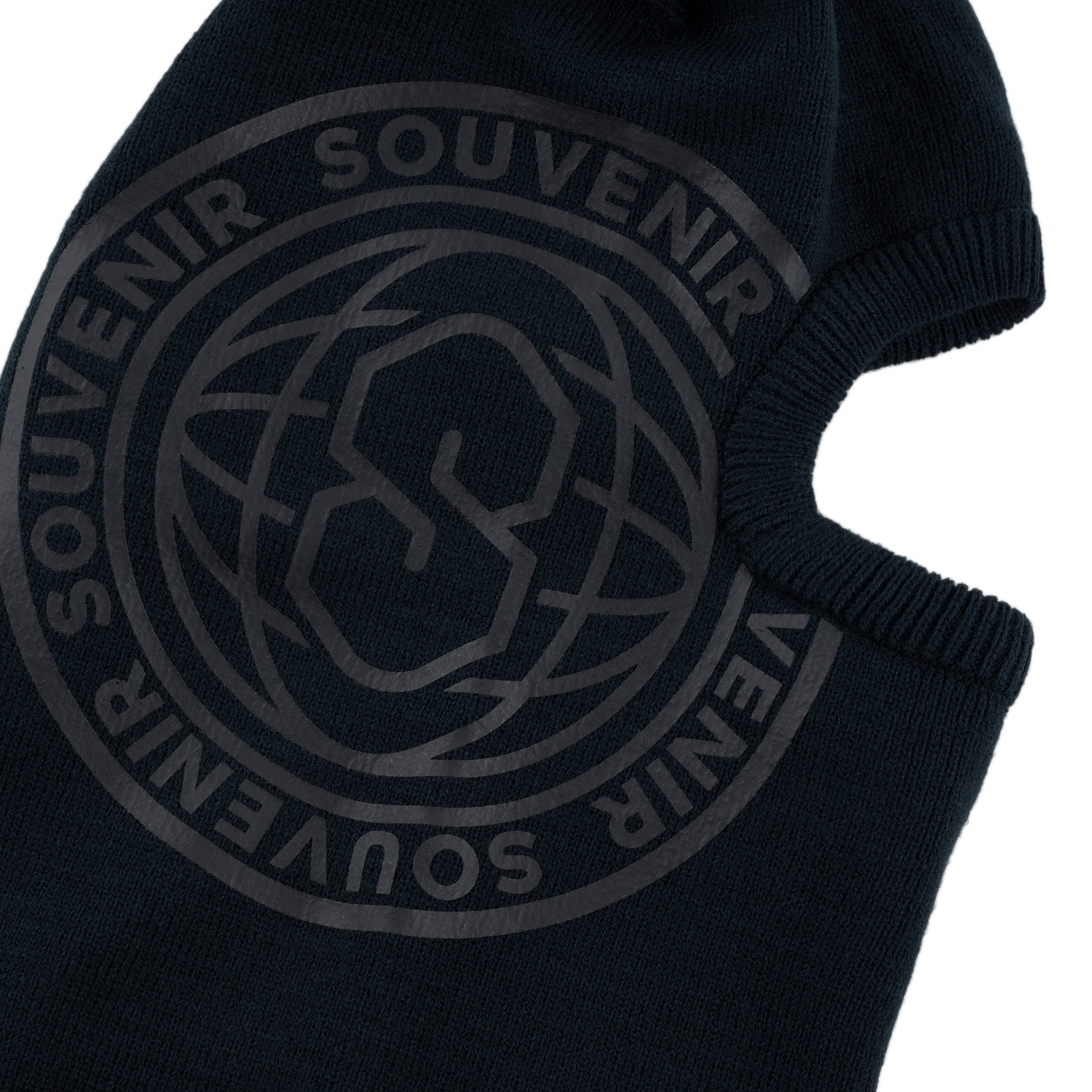 Close-up of the Souvenir Printed Burglar Mask in Black showing the large tonal Souvenir globe logo on the rib knit balaclava.