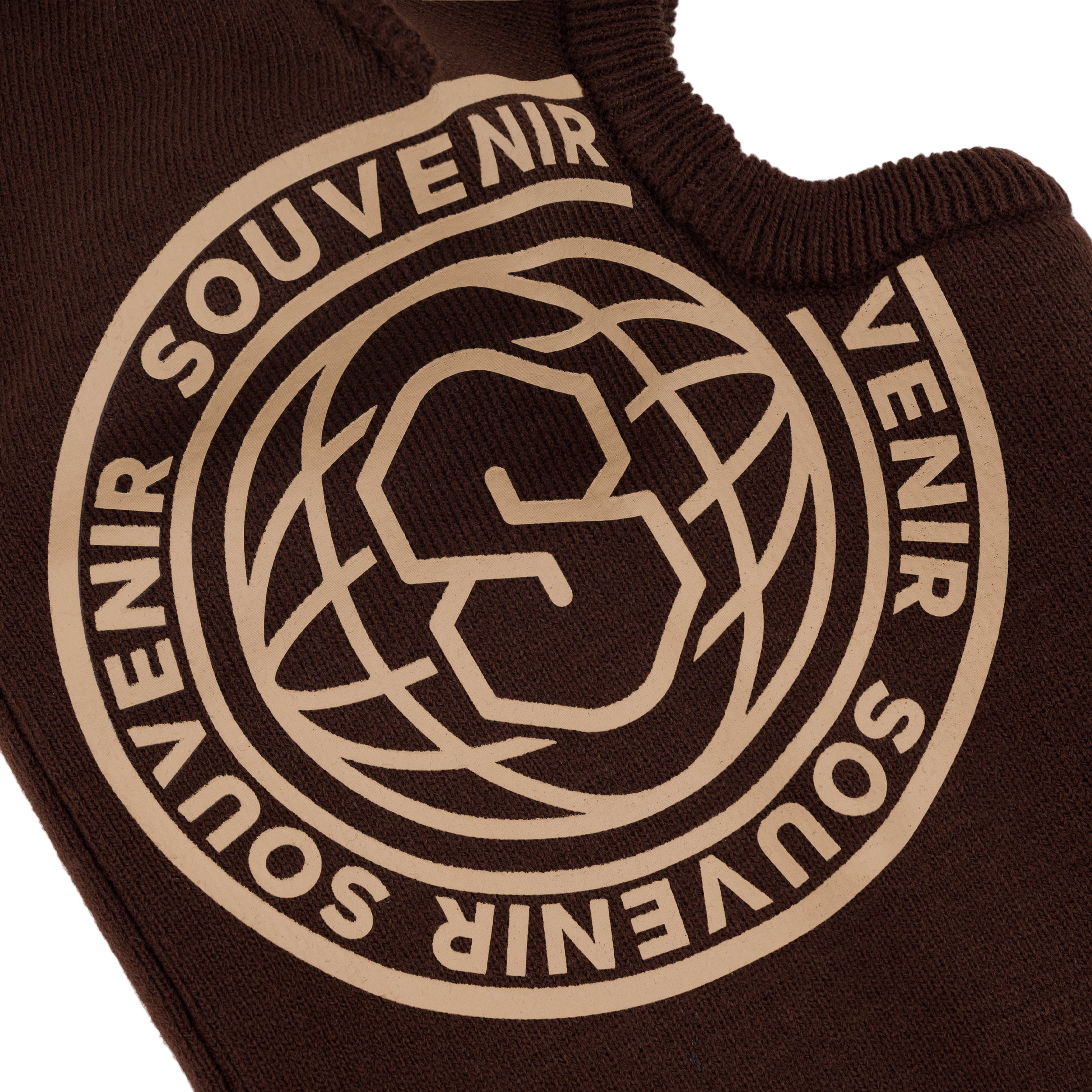 Close-up of the Souvenir Printed Burglar Mask in Chocolate showing the large contrast Souvenir globe logo on the rib knit balaclava.