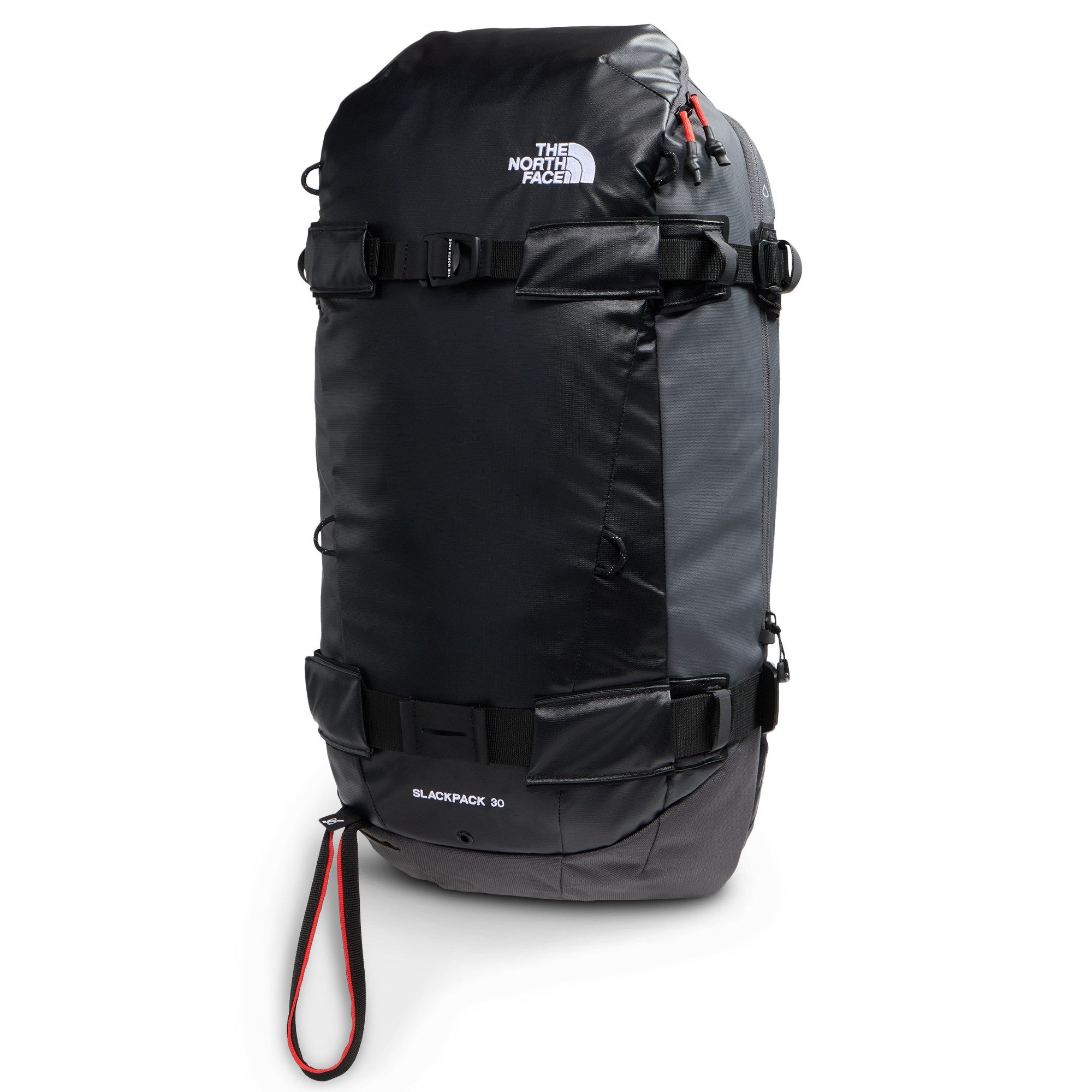 The North Face Slackpack 30 snow backpack in Anthracite Grey and TNF Black shown from a front three-quarter angle with snowboard carry straps and red webbing accents.