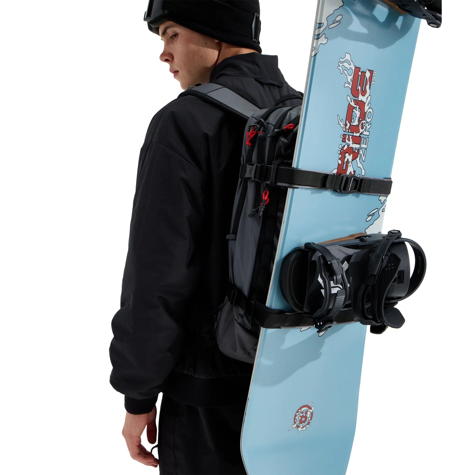 The North Face Snowdrift 22 + 6 snow backpack worn with a snowboard secured vertically using the external board carry straps.
