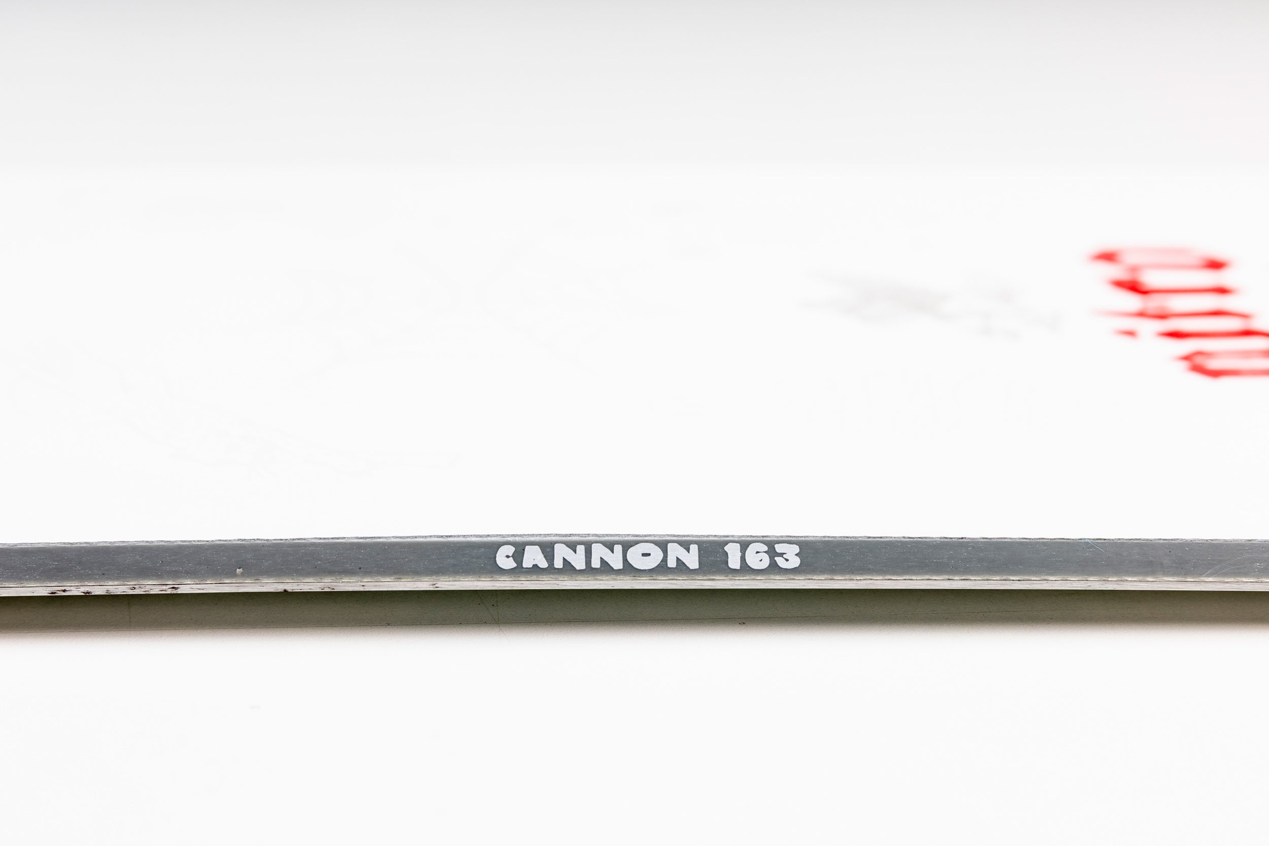 Nitro Cannon Quiver Series snowboard 2027 sidewall view, showing the black and white graphic design and construction details.