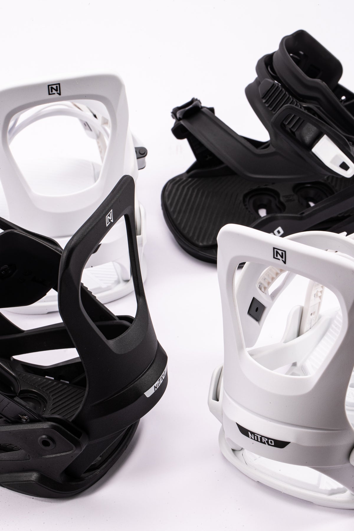 Nitro Charger Micro kids' snowboard bindings on snow, designed for young riders, featuring adjustable straps and durable construction.