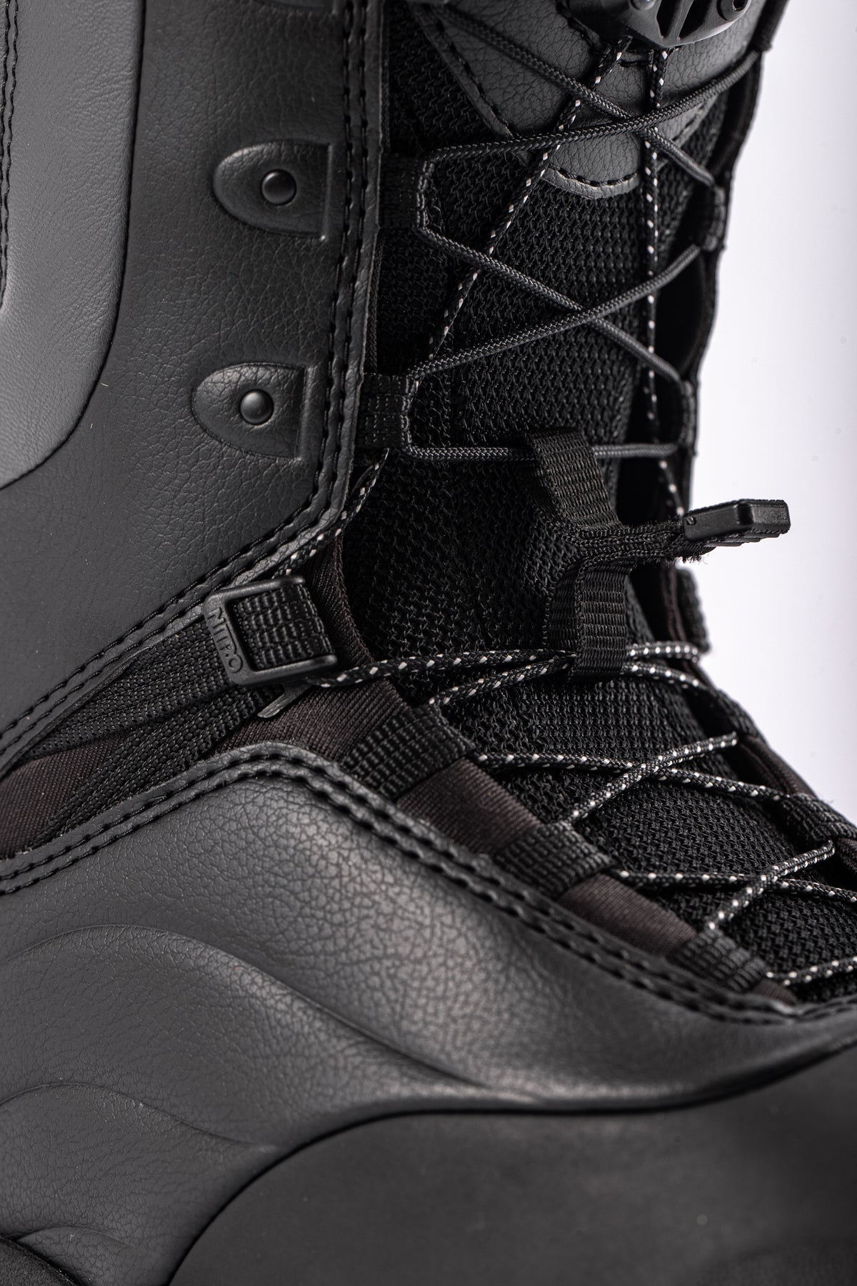 Nitro Crown TLS women's snowboard boots with lace closure, designed for snowboarding, shown with close-up of lace detail.