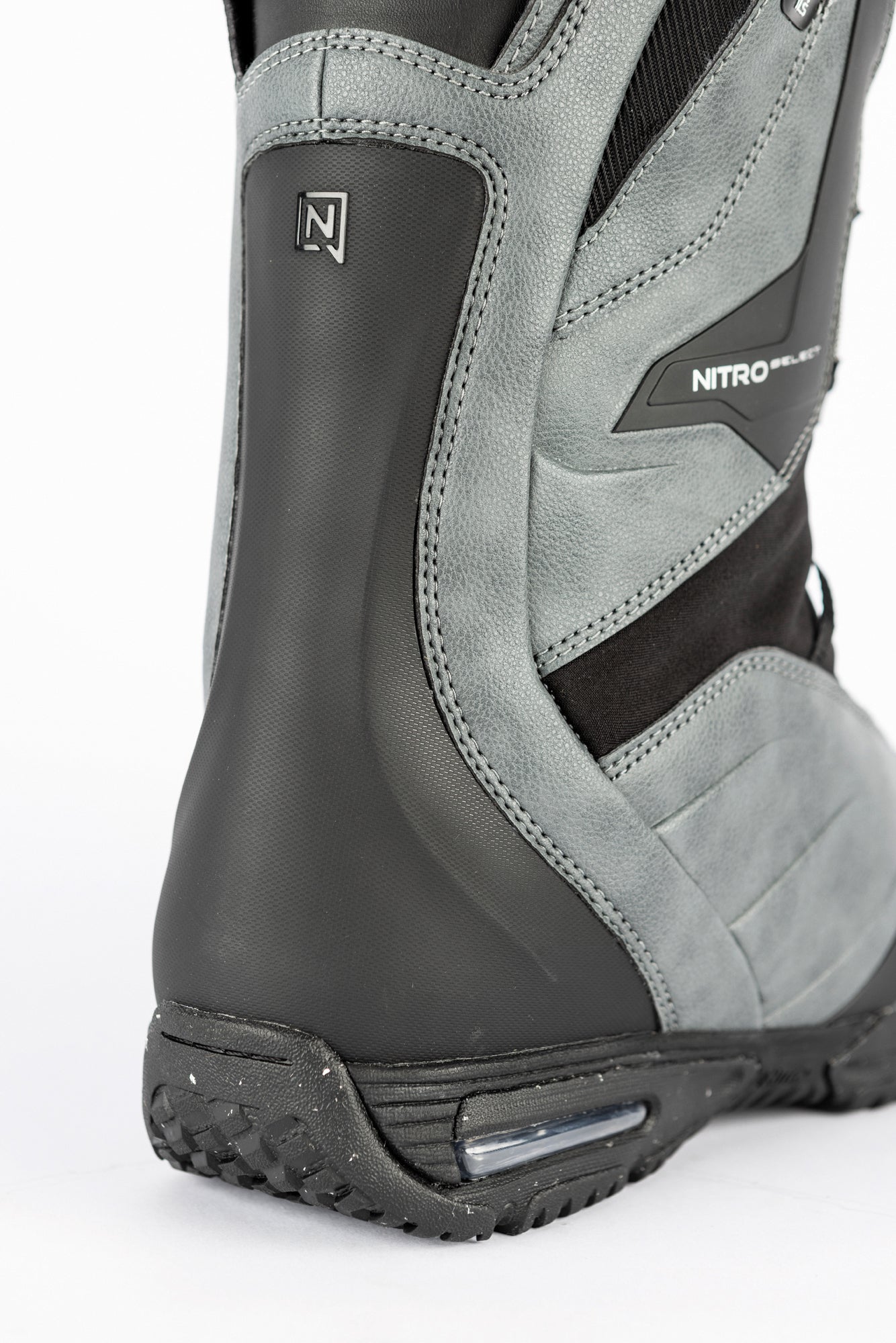 Back view of Nitro Select TLS+ snowboard boots 2027, featuring black and white design and secure lacing system for snowboarding.