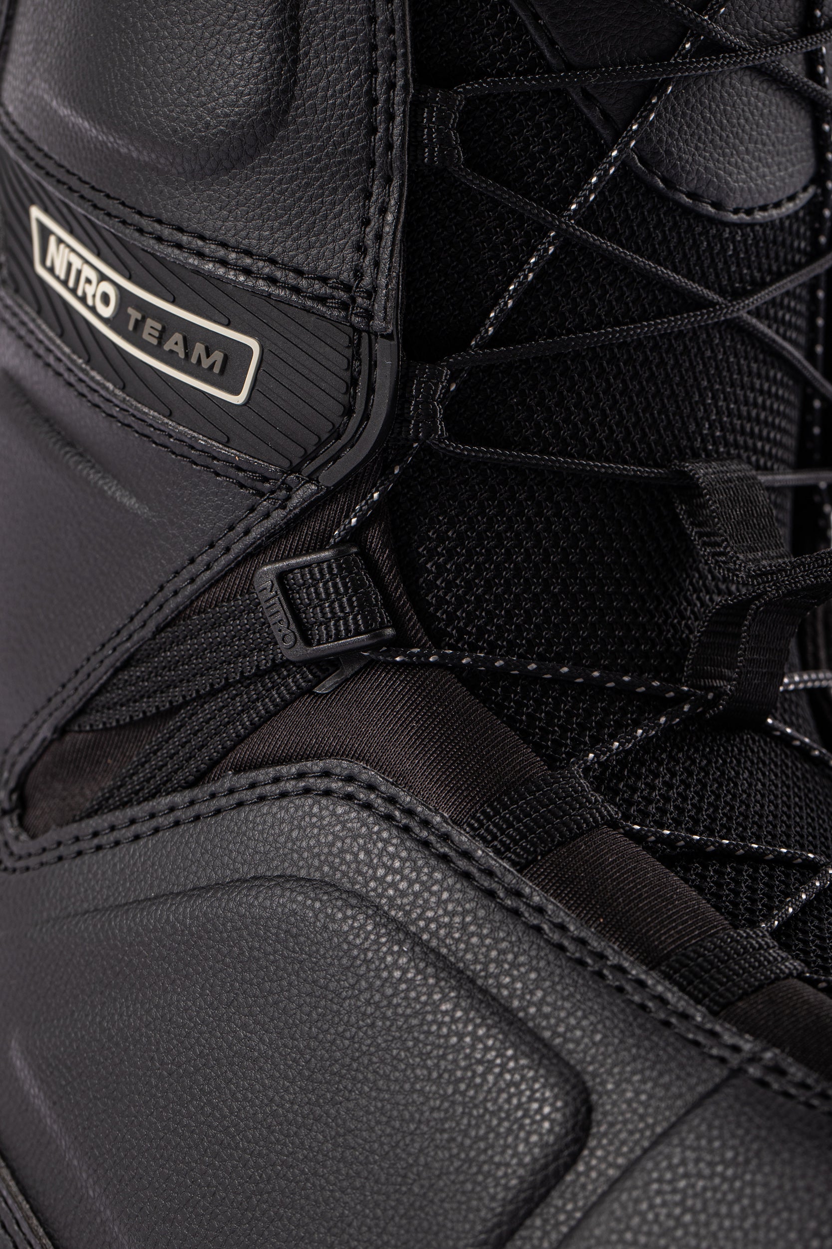 Black Nitro Team TLS Snowboard Boots with laces, designed for snowboarding, featuring a sturdy, comfortable fit.