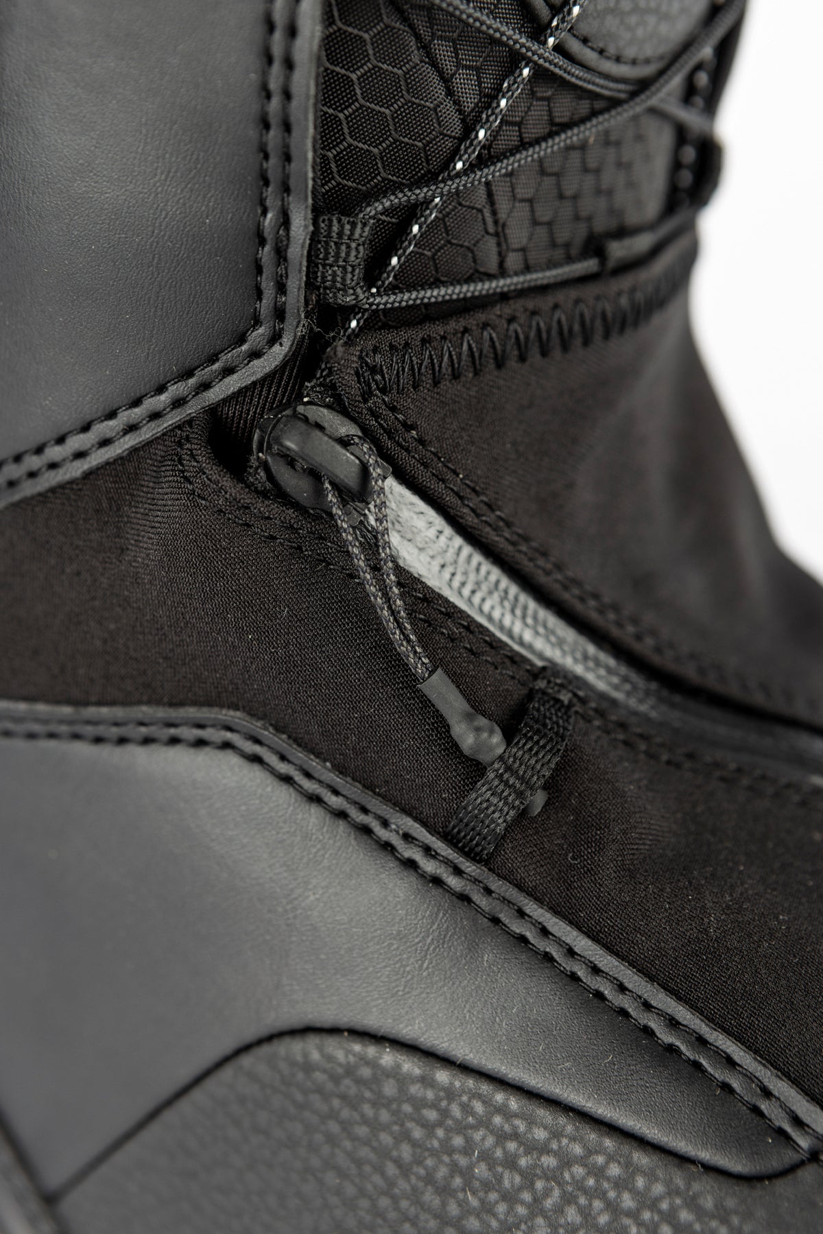 Black Nitro Venture Pro TLS snowboard boots with zipper detail, designed for snowboarding performance and comfort.