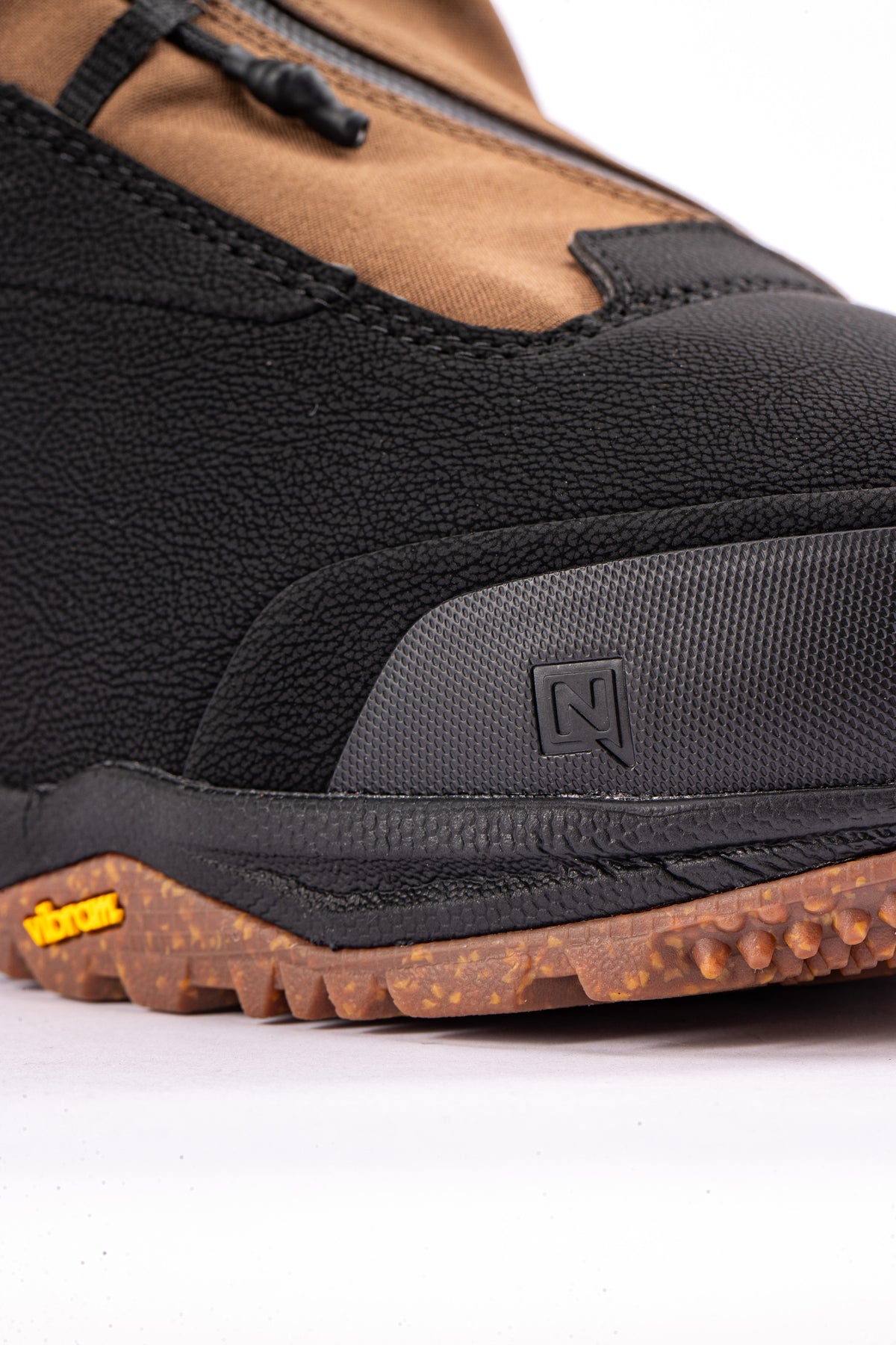 Nitro Venture Pro TLS snowboard boots in brown and black with toe detail, designed for winter snowboarding.