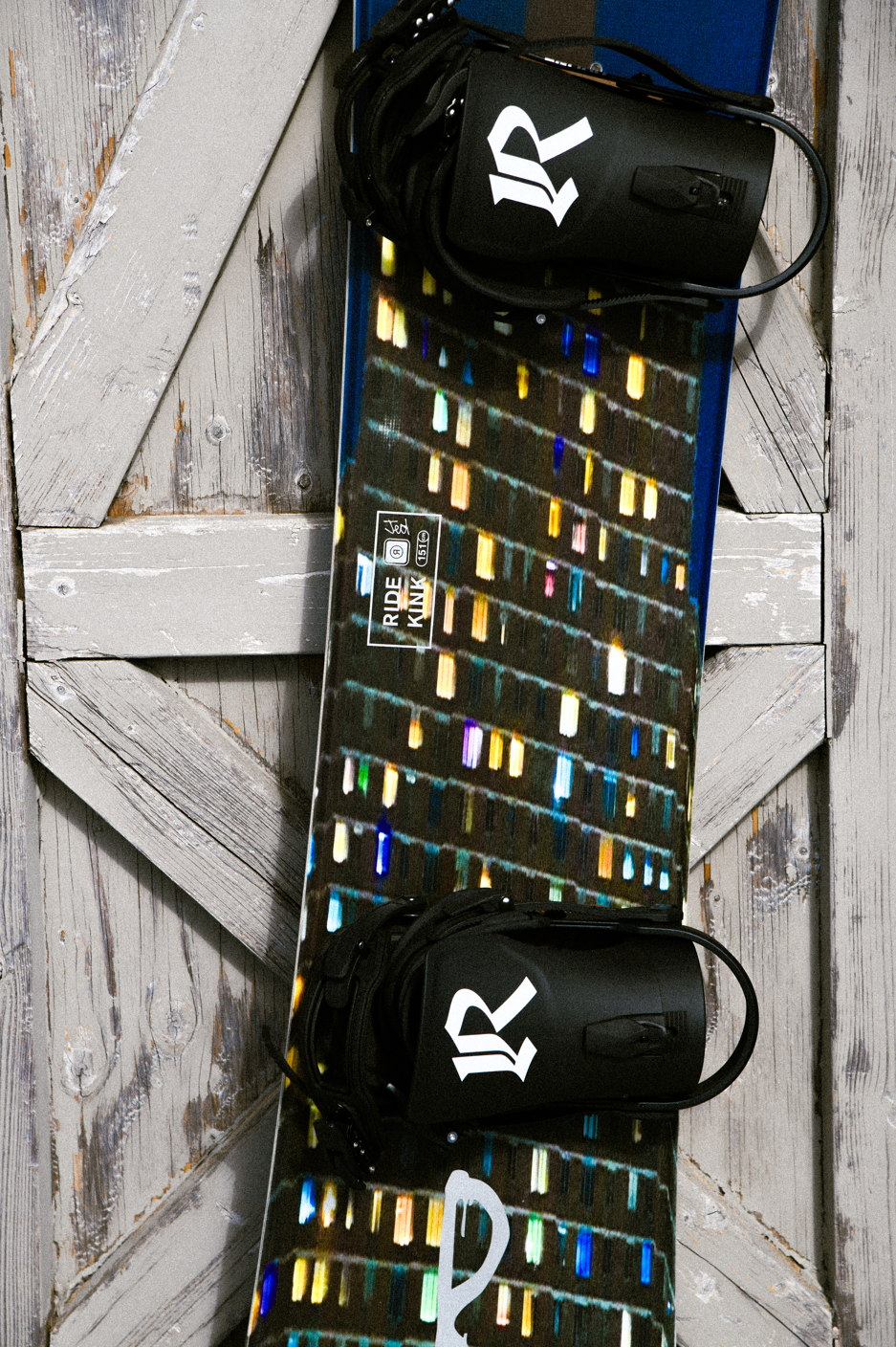Close-up of the Ride Kink Snowboard 2027 top sheet showing detailed graphic and design elements.