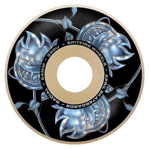 A single skateboard wheel with a black background and metallic silver monster graphics, featuring a tan center ring with white text that reads Spitfire 99DU SPITFIRE WHEELS APRIL SKATEBOARDS RADIAL